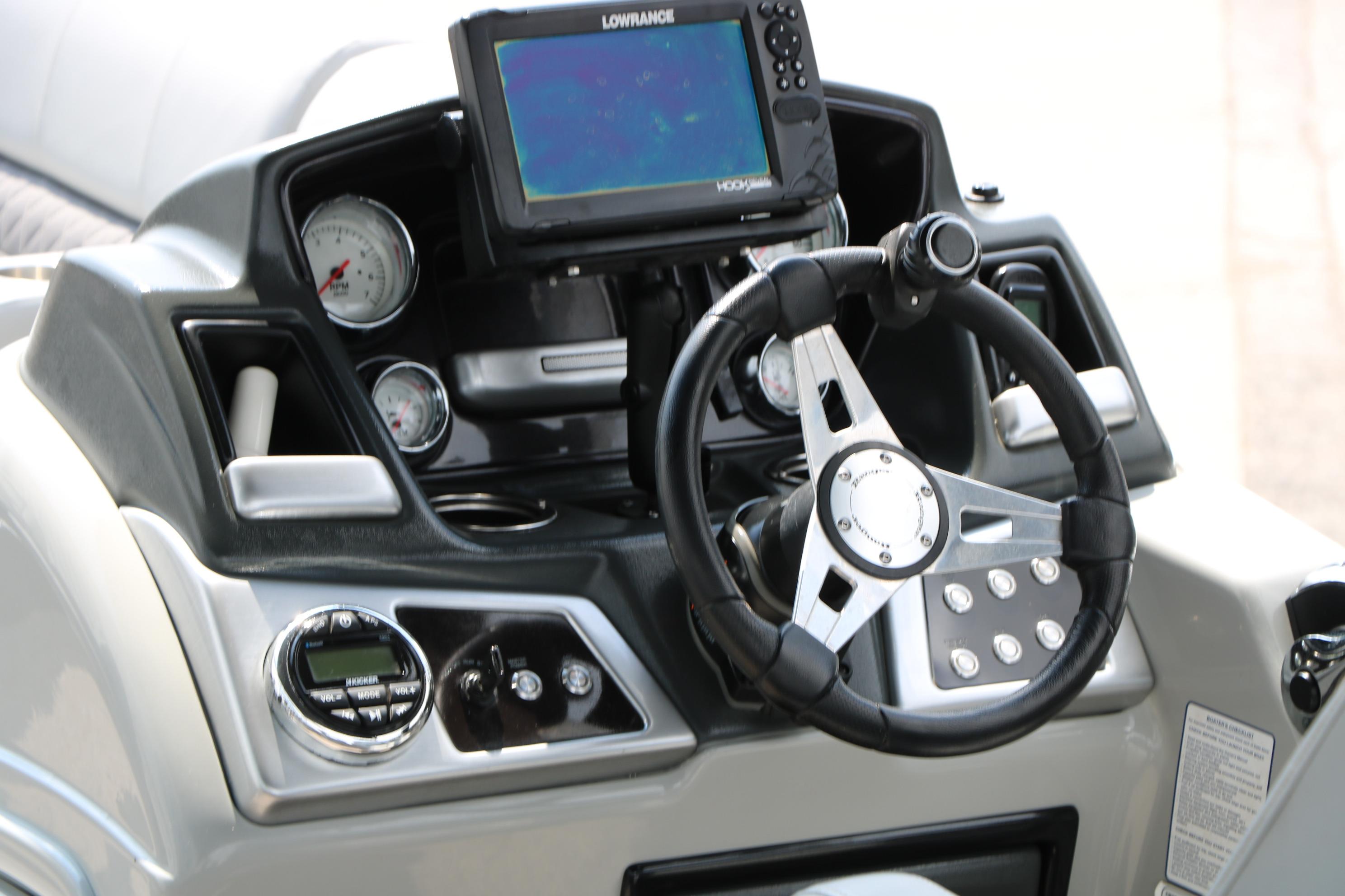 Dashboard of 2021 Ranger 223FC boat with steering wheel and navigation system.