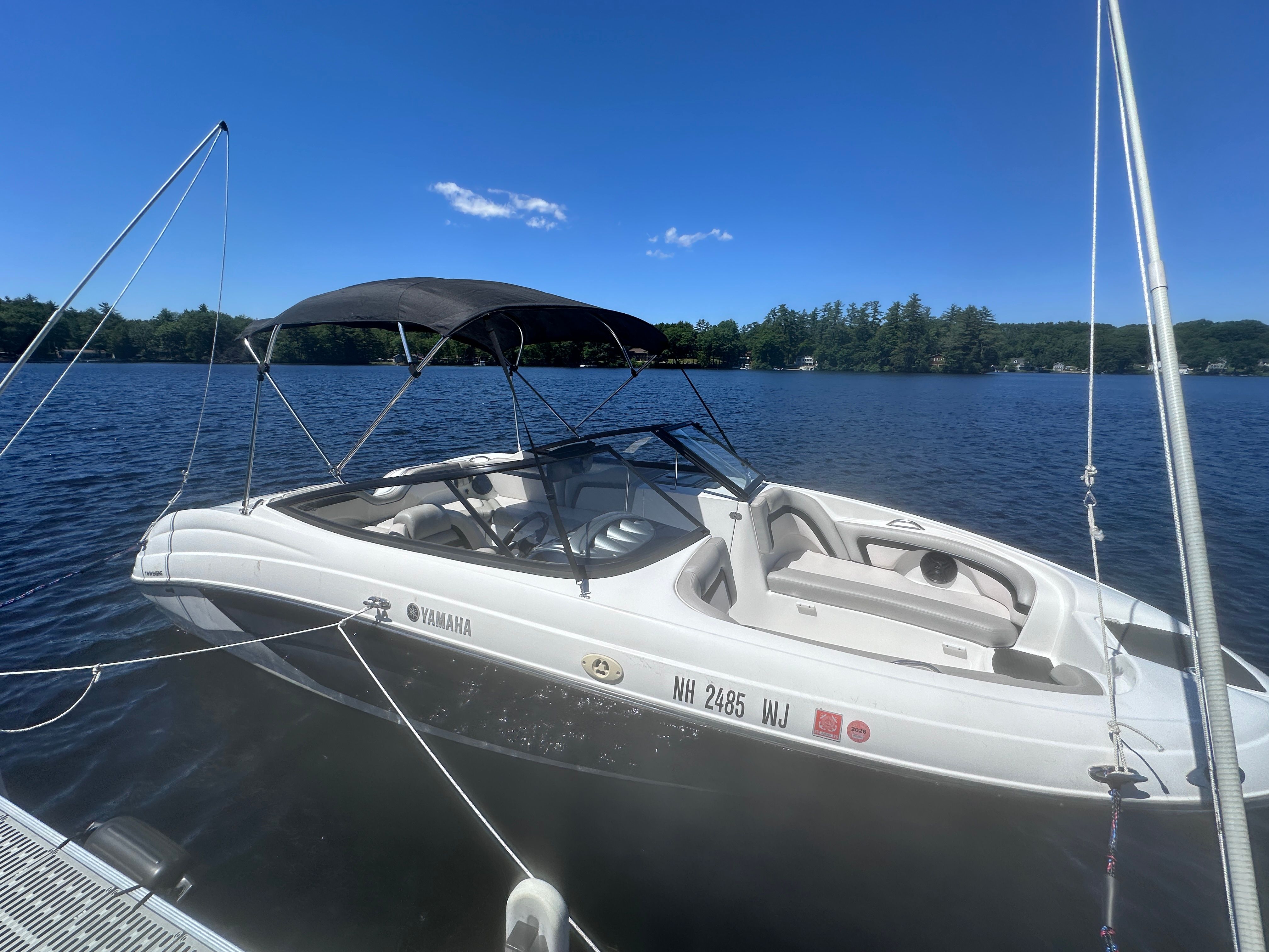 2010 Yamaha 212SS boat on a calm lake.