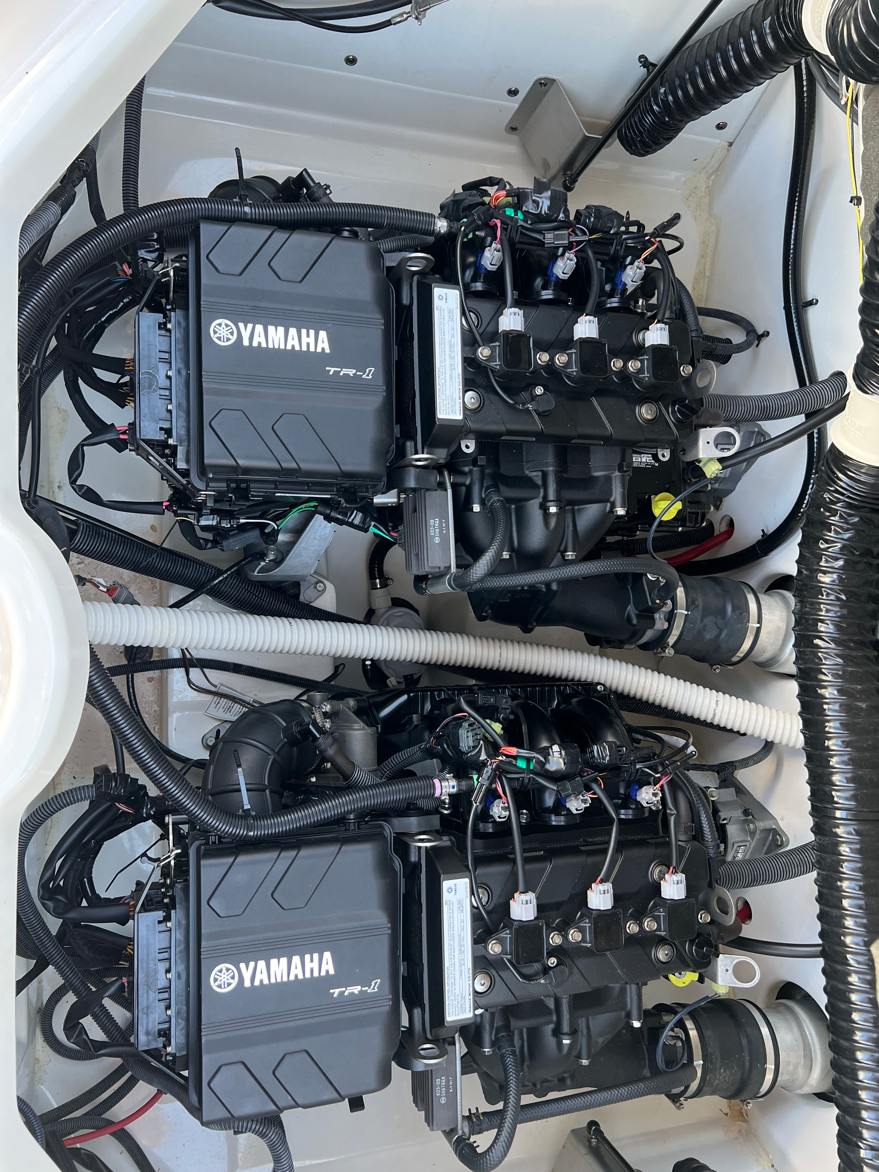 Two Yamaha engines in a boat's engine compartment, clean and well-organized.