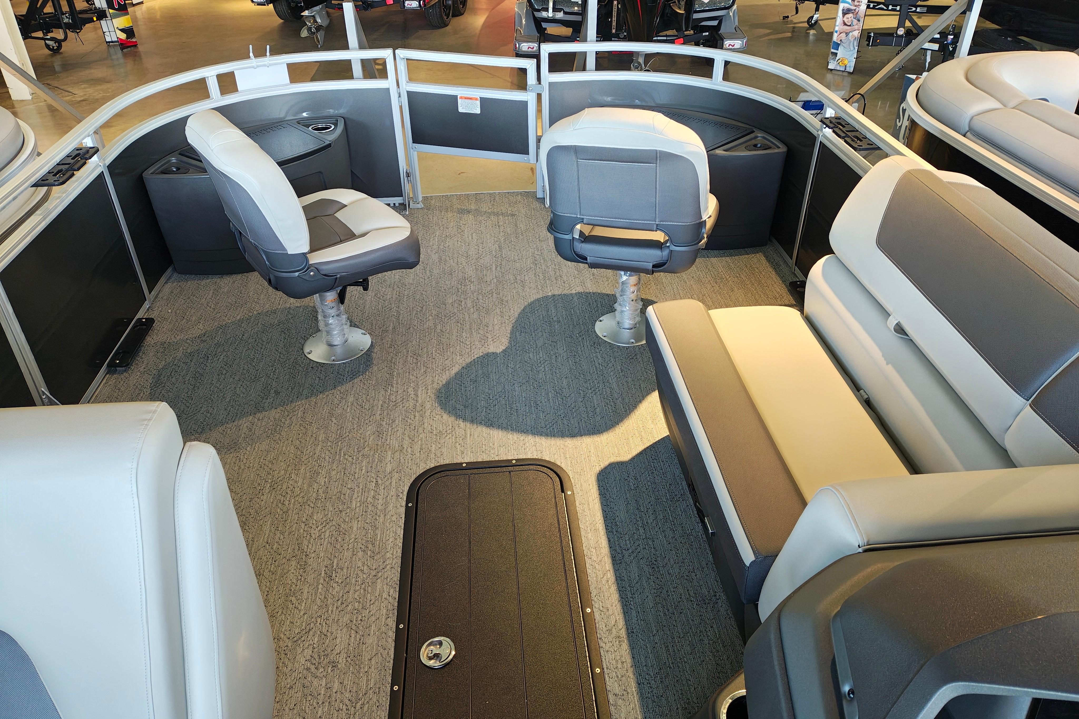 2026 Sun Tracker Fishin' Barge 22 XP3 interior with seating and carpeted floor.