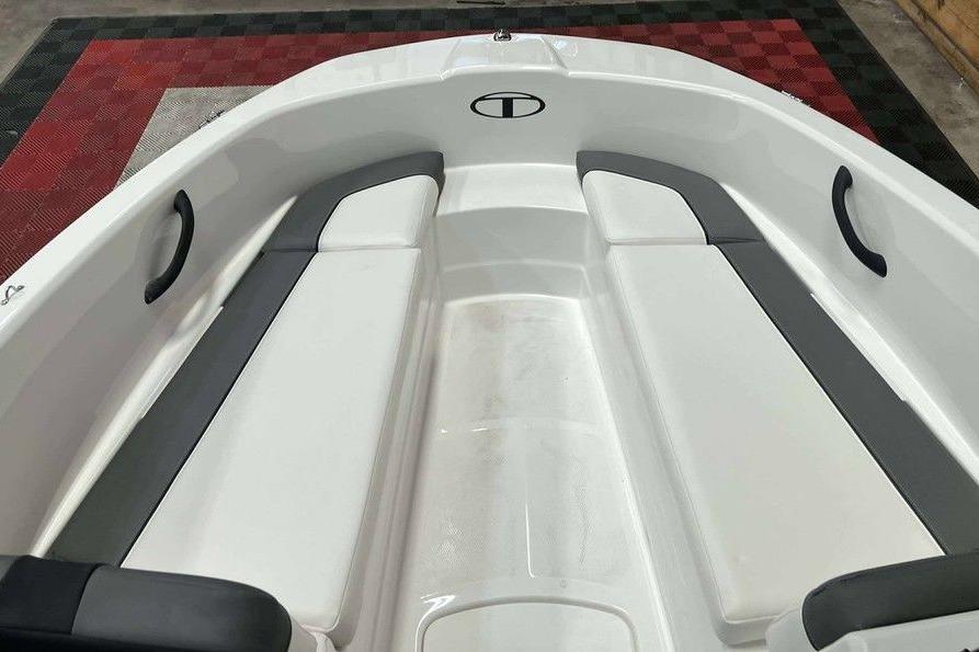 2026 Tahoe T16 boat interior with white and gray seating, black handles, and red checkered floor.