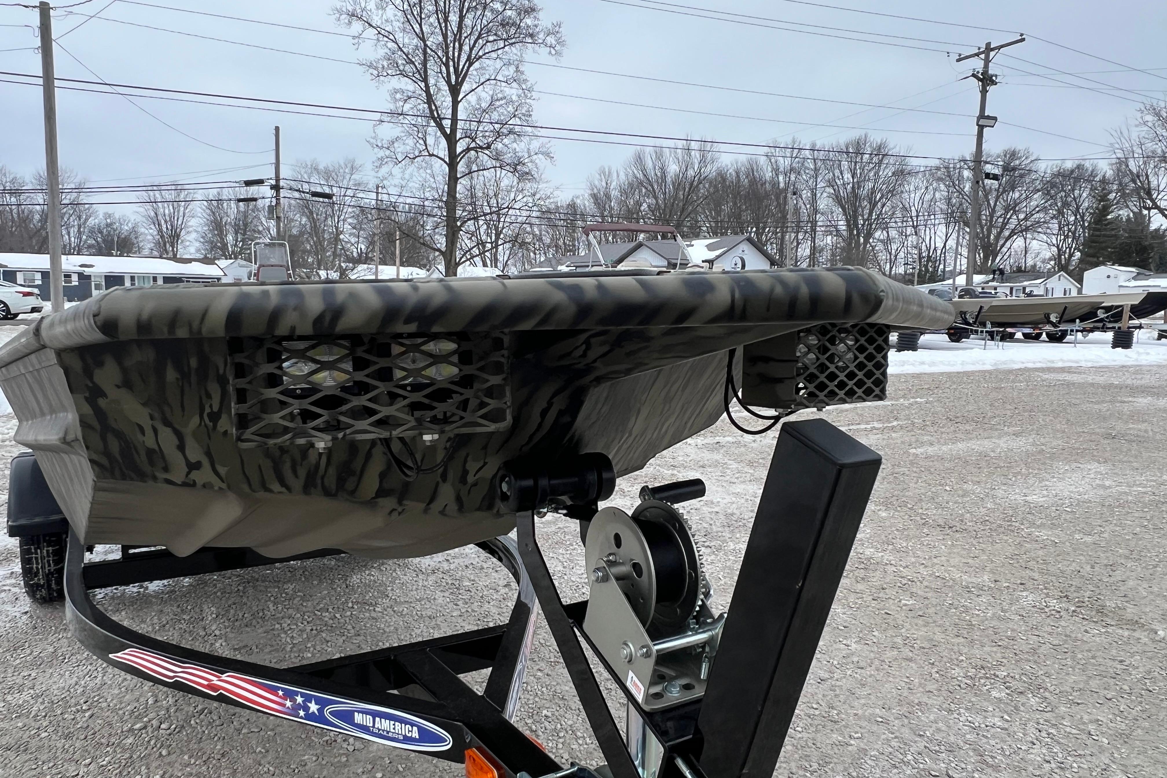 2026 SeaArk 1648 MV Special boat on trailer in snowy outdoor setting.