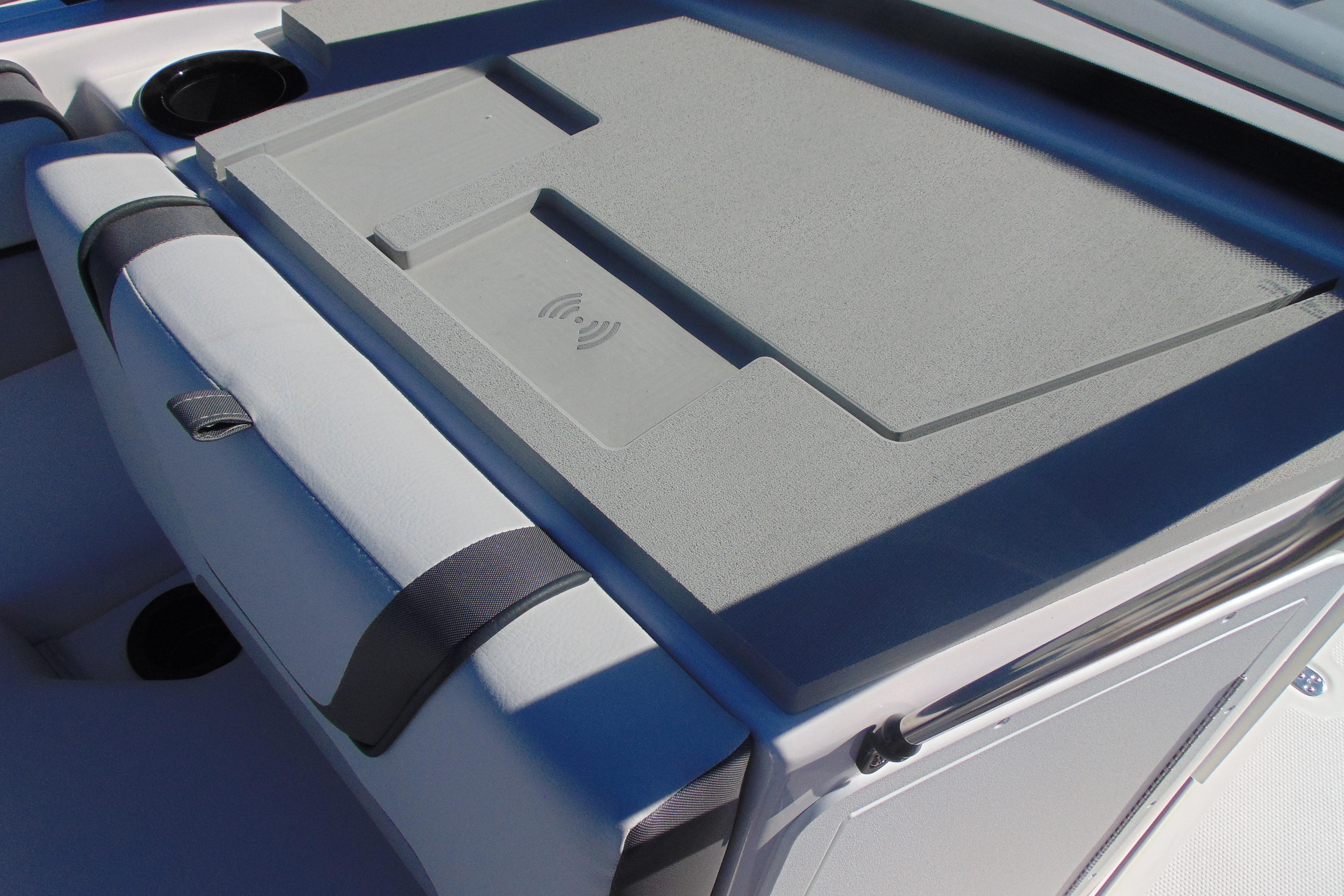 2026 Yamaha Boats AR220 interior with wireless charging pad and cup holders.