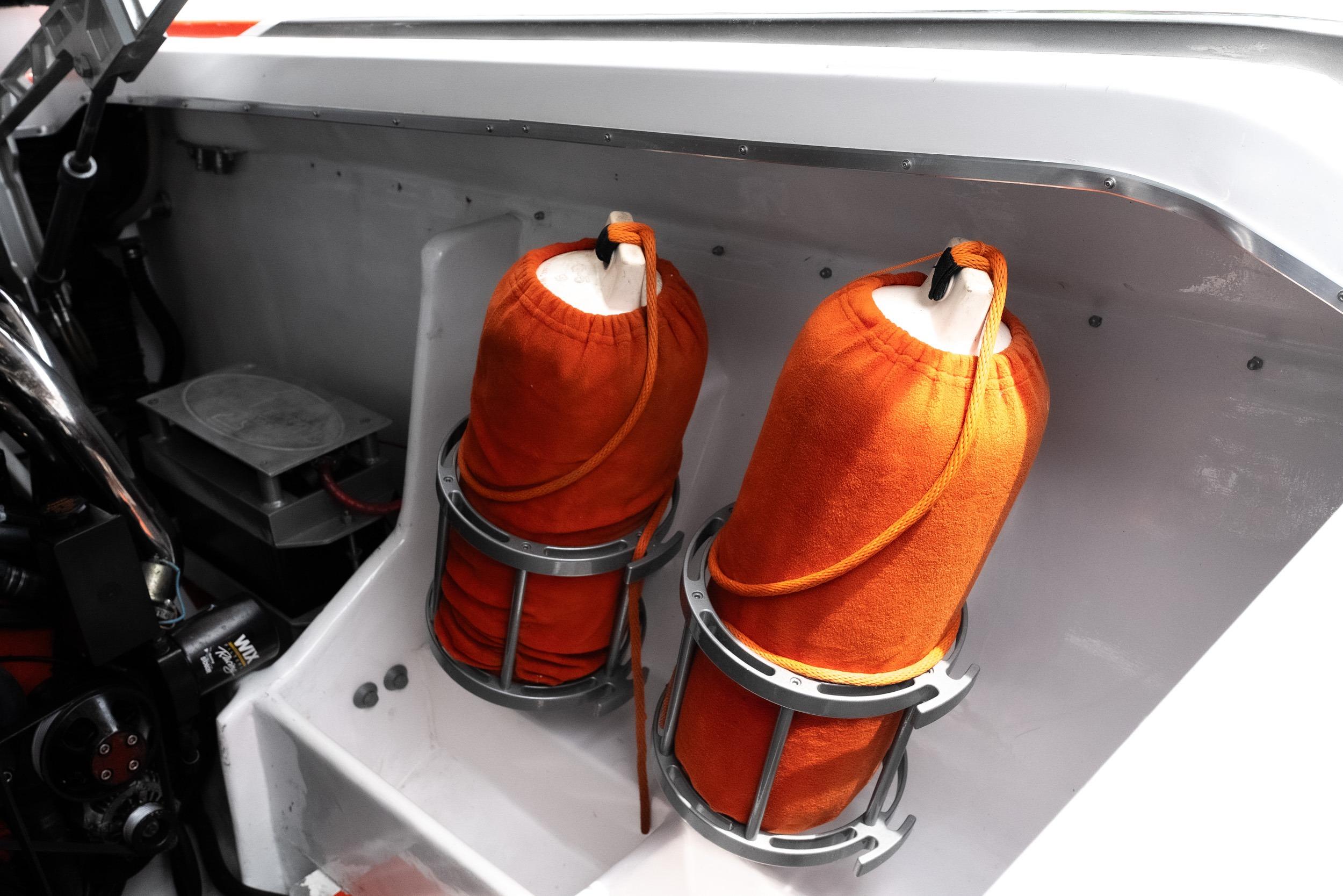 Orange fenders in a 2006 Cigarette 39' Top Gun Unlimited boat interior.