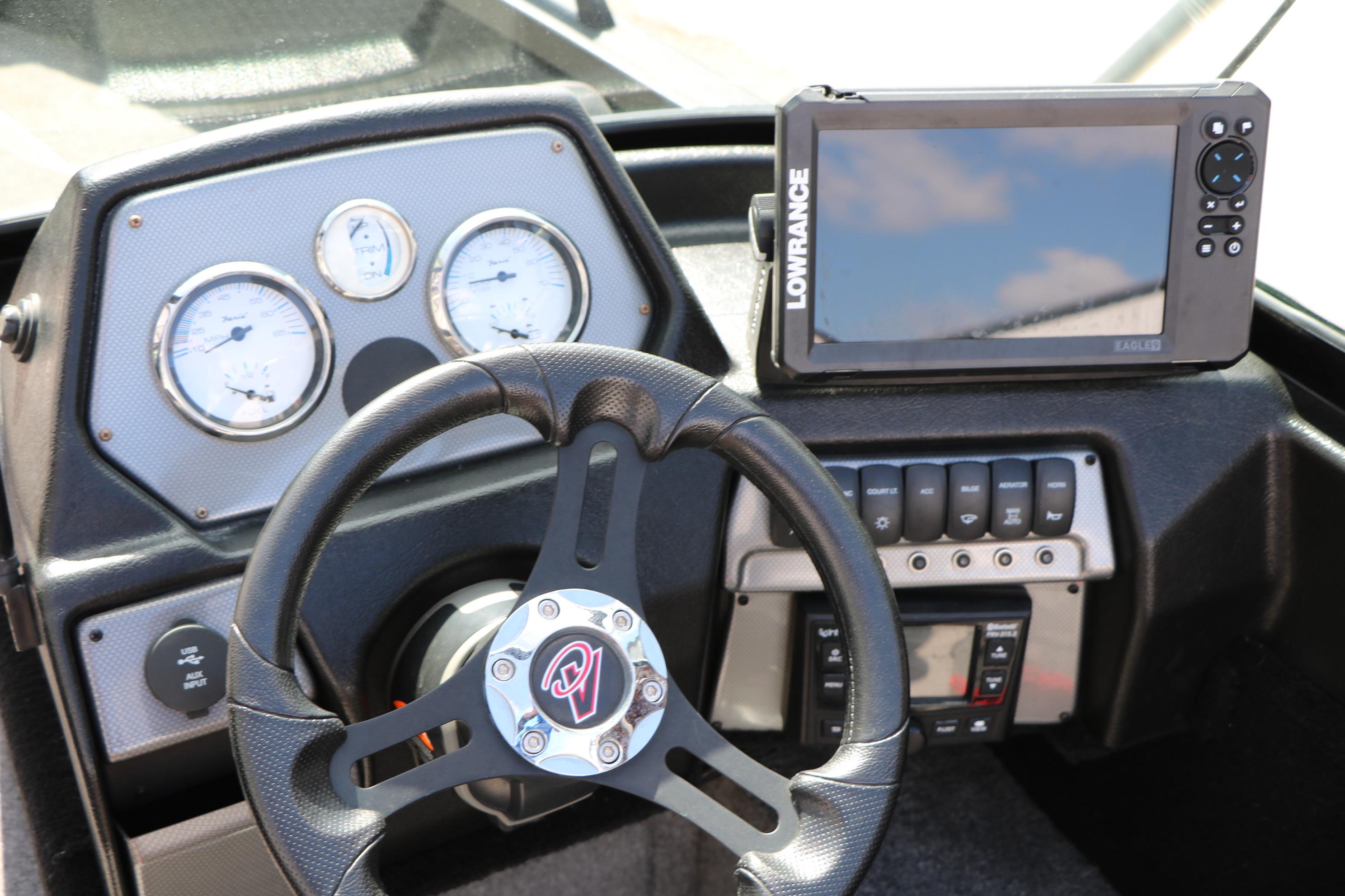 2023 Alumacraft Competitor FSX 185 dashboard with steering wheel and Lowrance fishfinder.