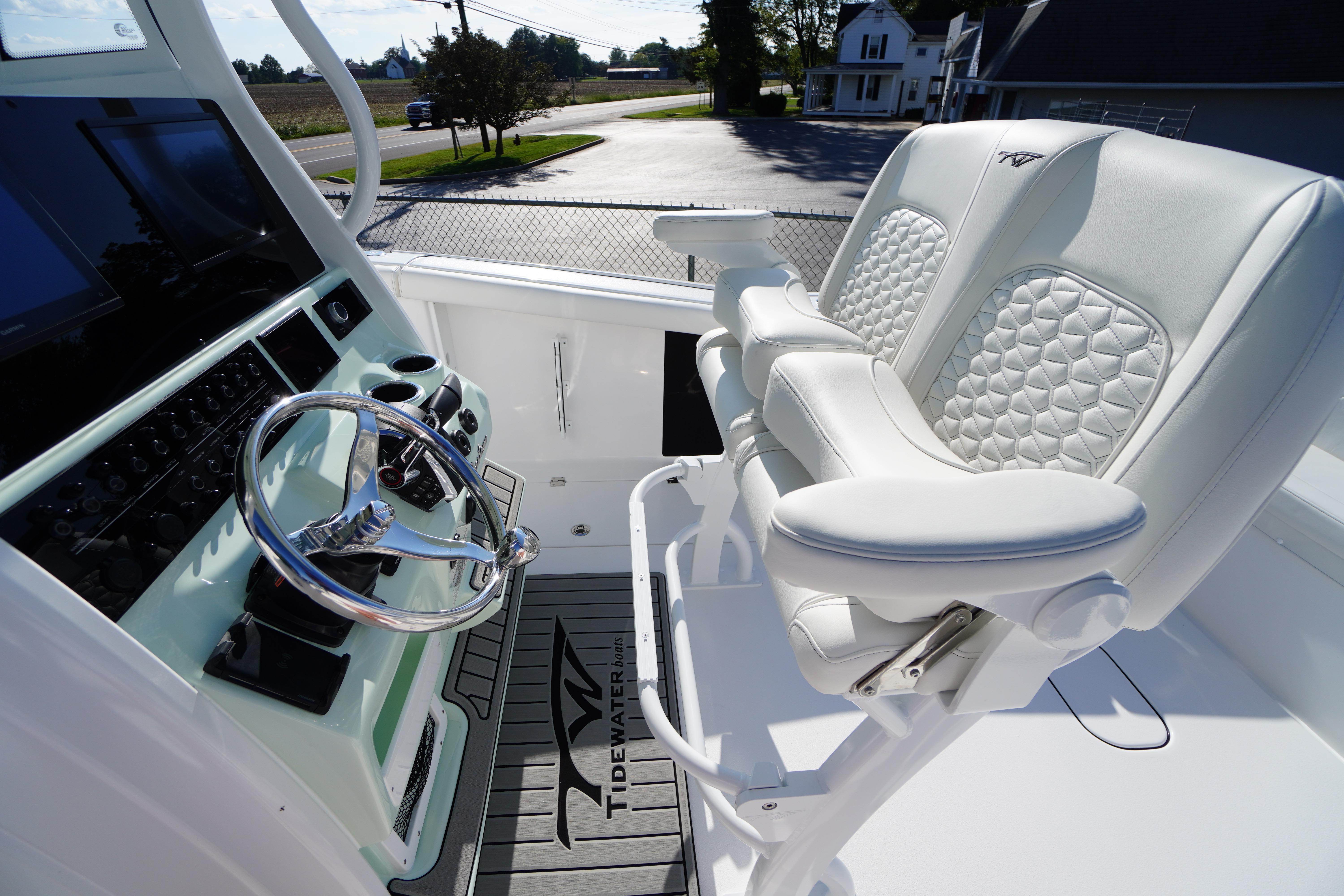 2026 Tidewater 272 LXF boat interior with steering wheel and luxurious seating.