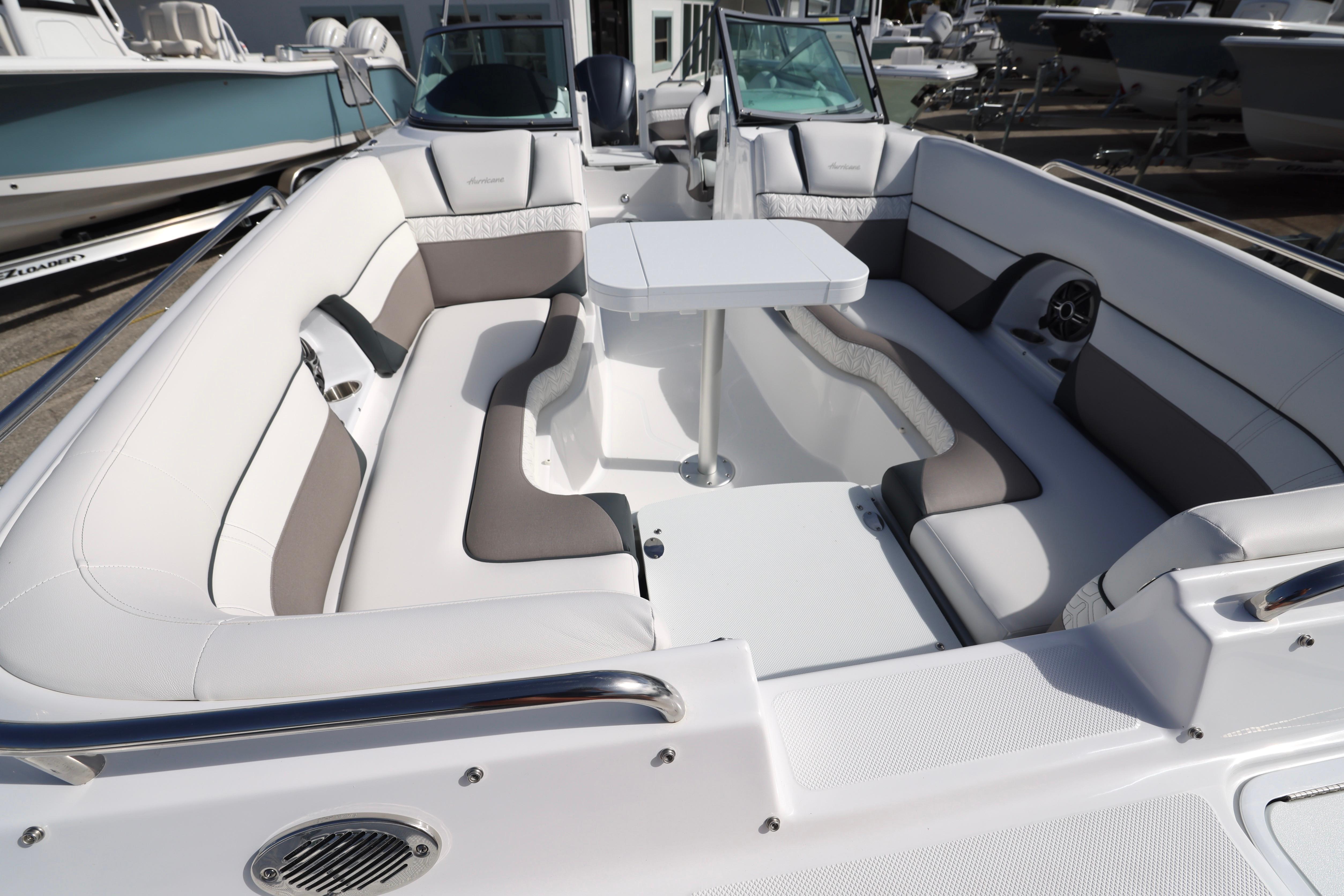 2026 Hurricane SunDeck 2486 OB boat interior with spacious seating and table.