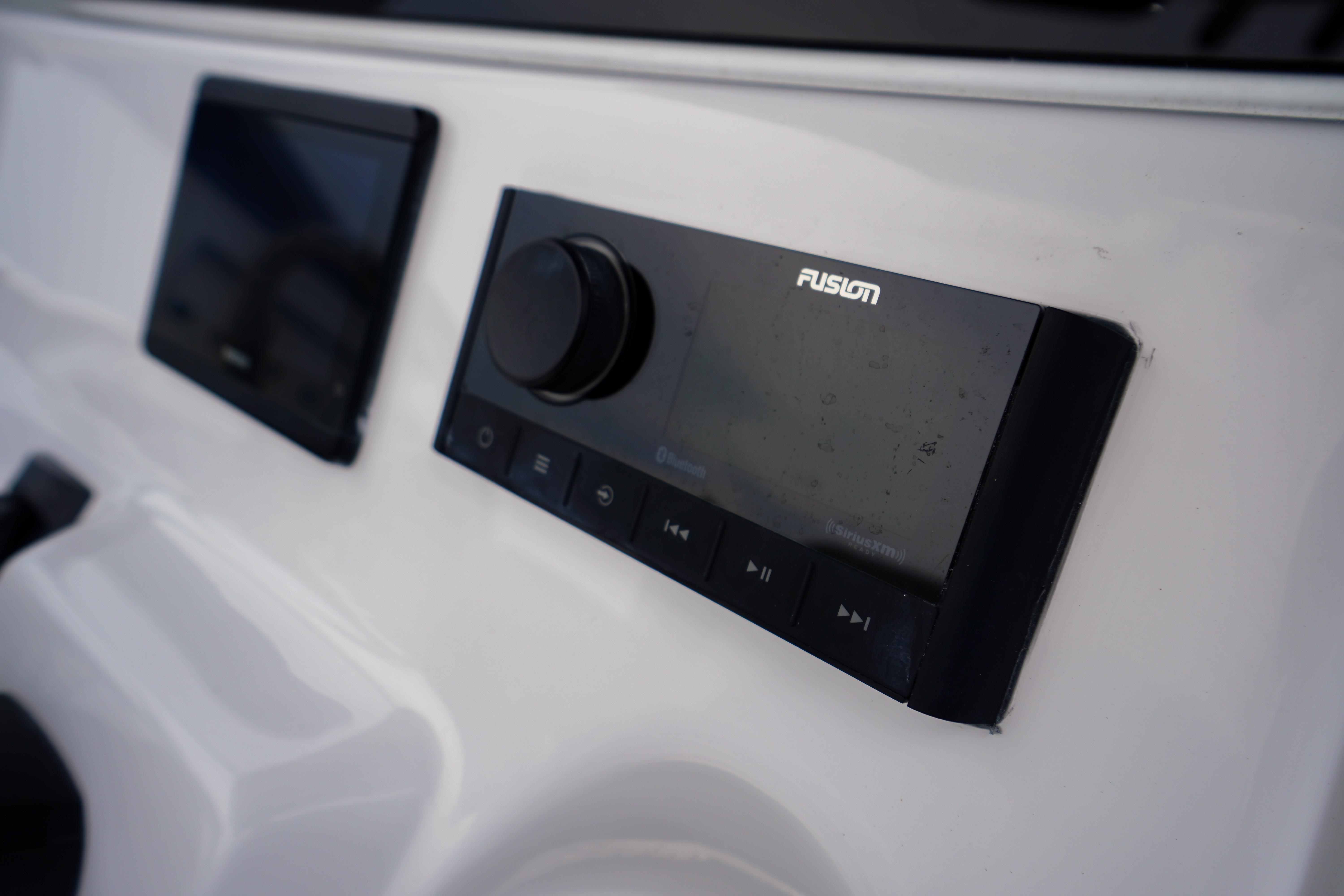 Close-up of Fusion audio system on 2026 Tidewater 232 SS boat dashboard.