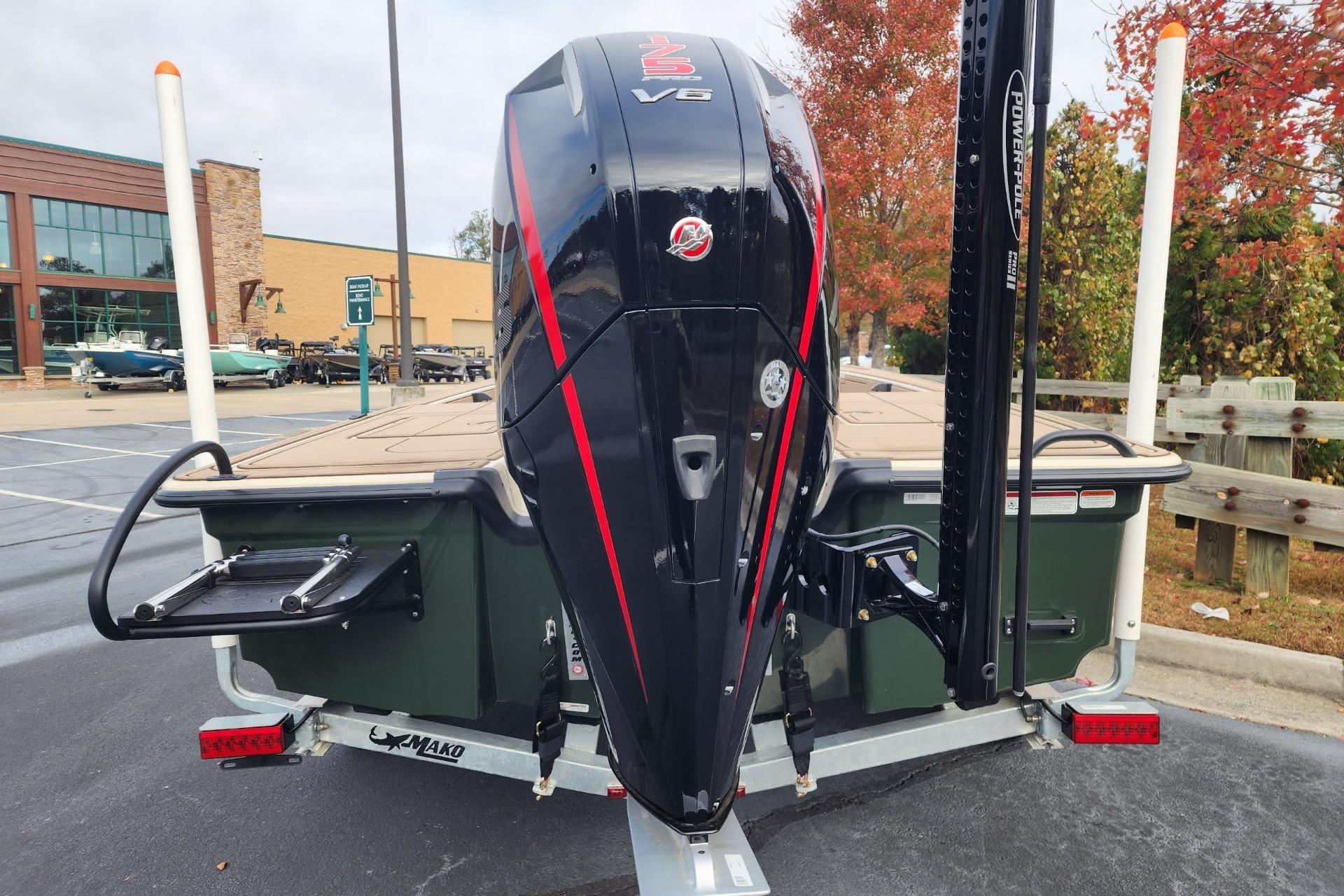2025 Mako 18 Pro Skiff Backwater Edition with powerful outboard motor in parking lot.