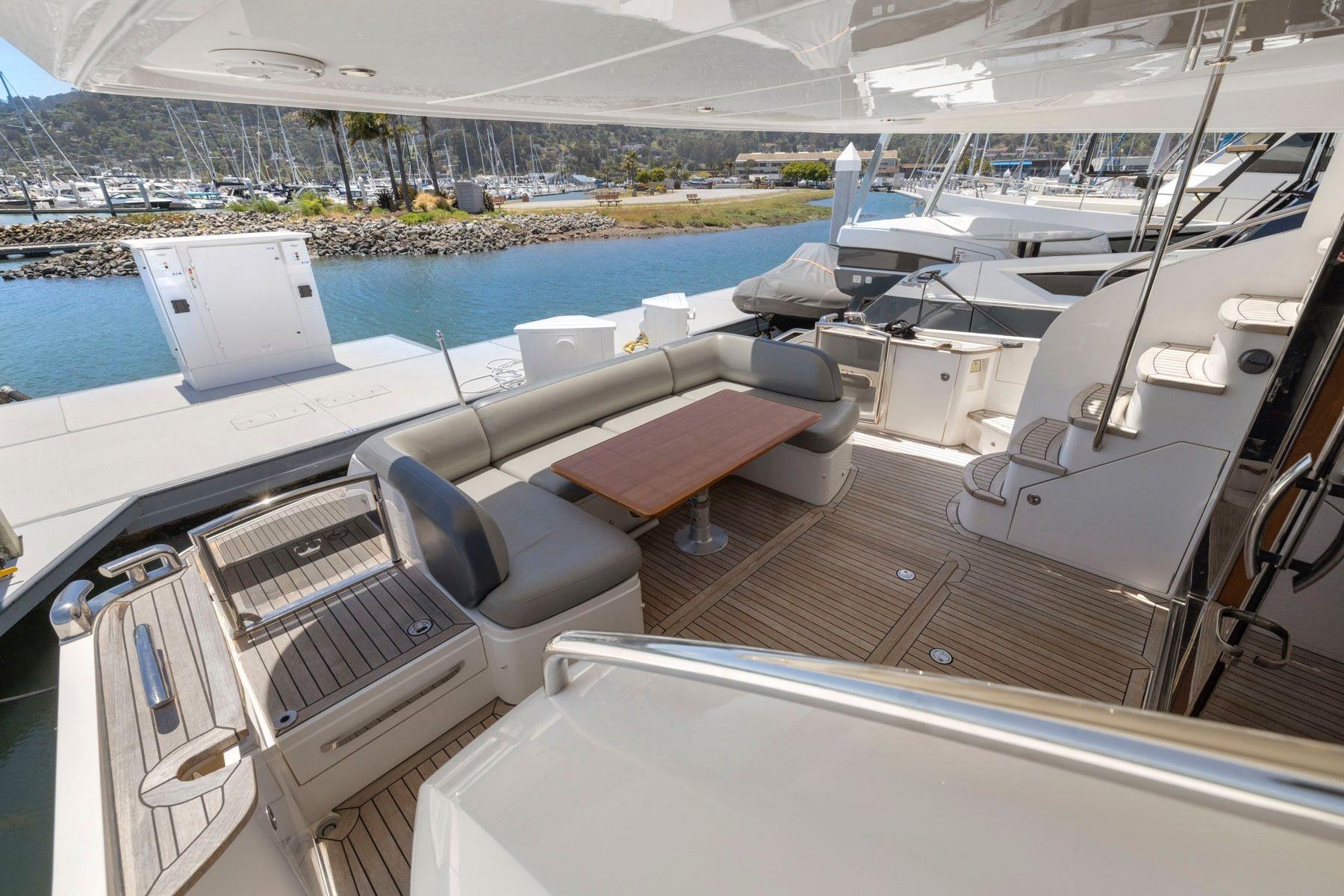 Luxurious 2015 Princess 60 Flybridge Motor Yacht with spacious deck and elegant seating area.