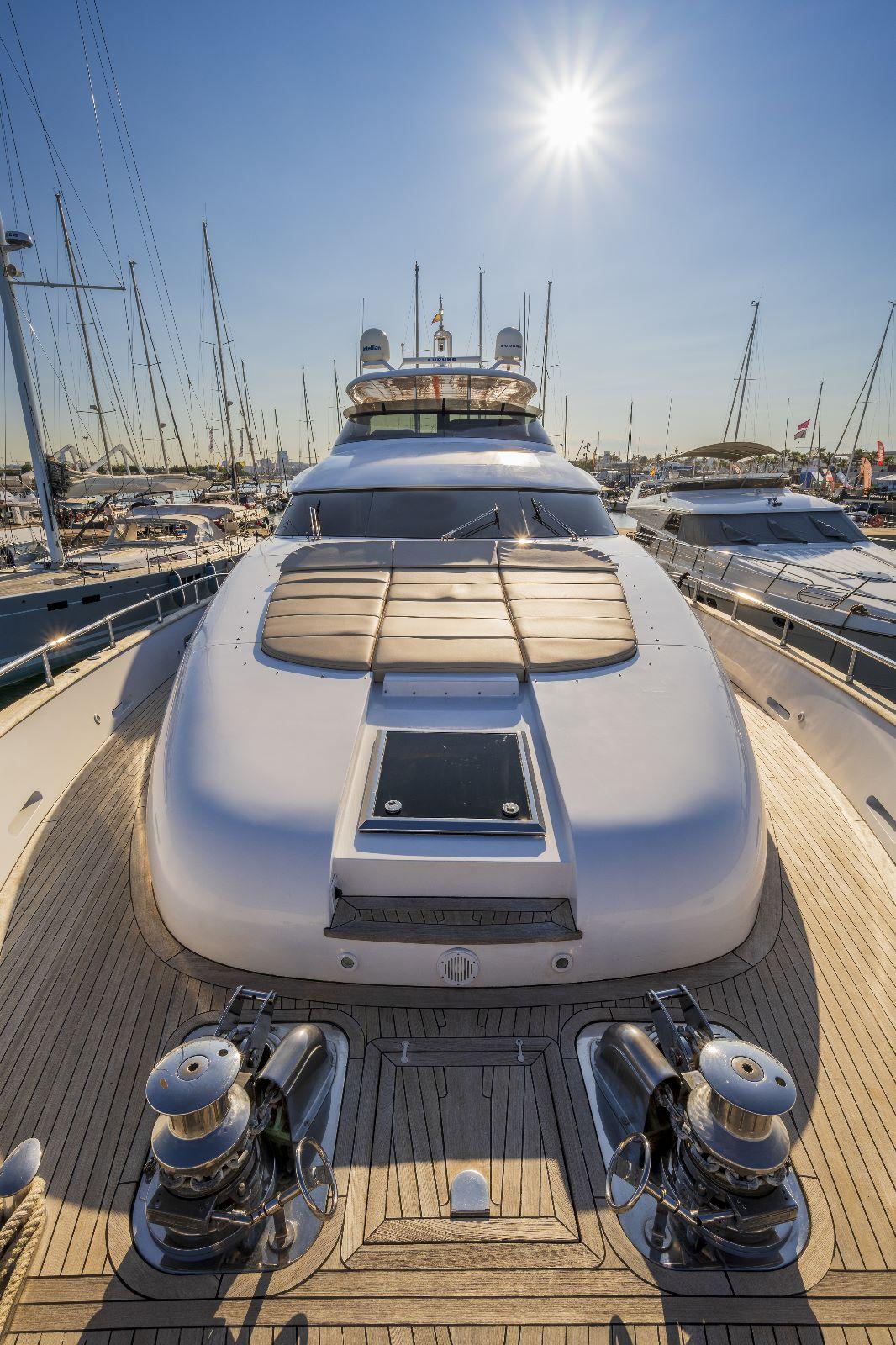 Luxurious 2011 Maiora 27 yacht docked under a bright sun in a marina.