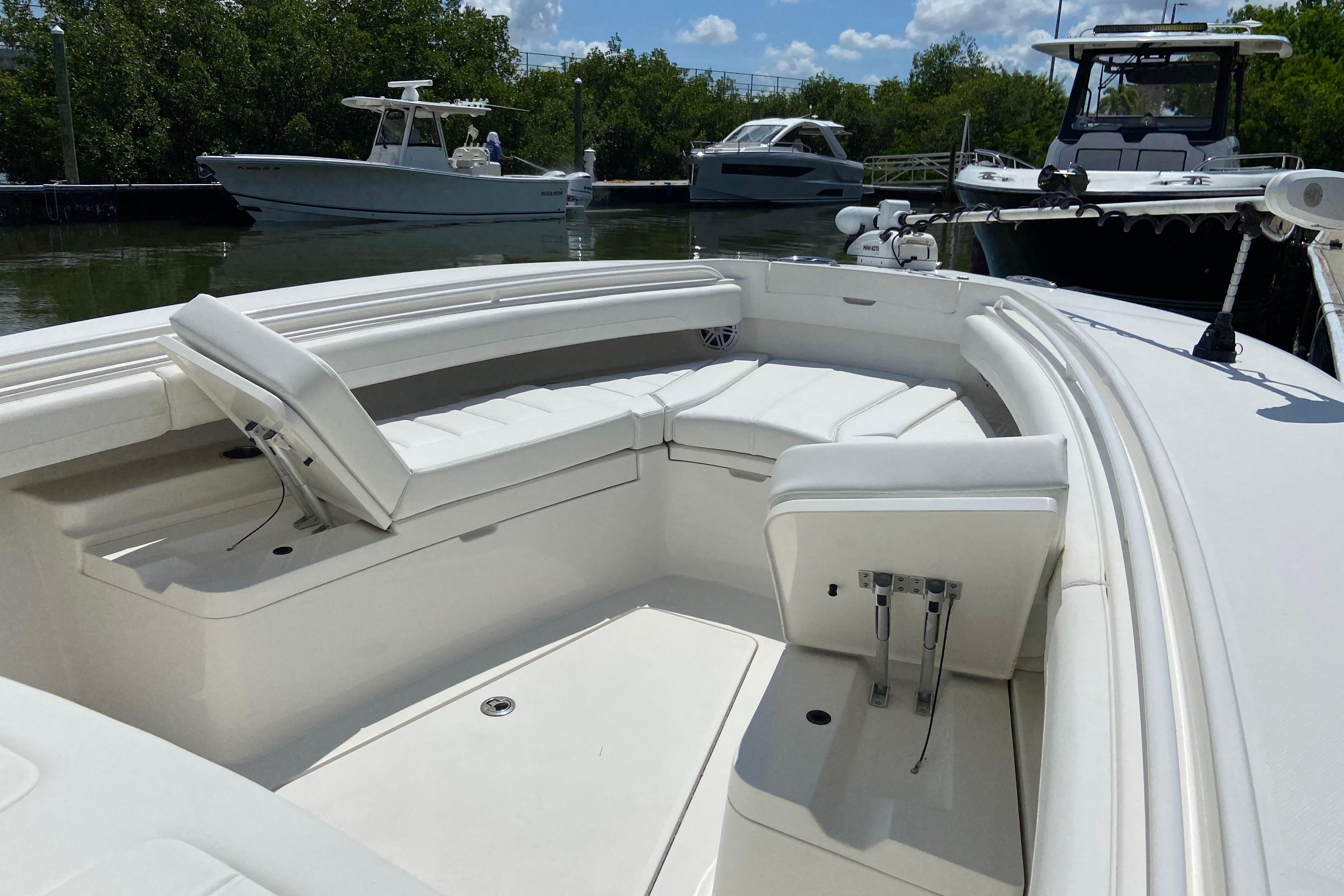 2021 Regulator 28 boat with spacious seating, docked near other boats.