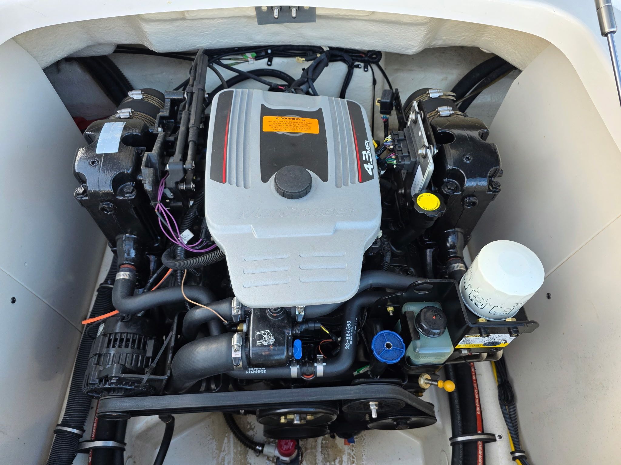 An engine compartment with a 4.3L V6 engine, clean and well-organized.