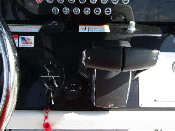 Close-up of 2024 Wellcraft 263 Fisherman boat control panel and throttle.