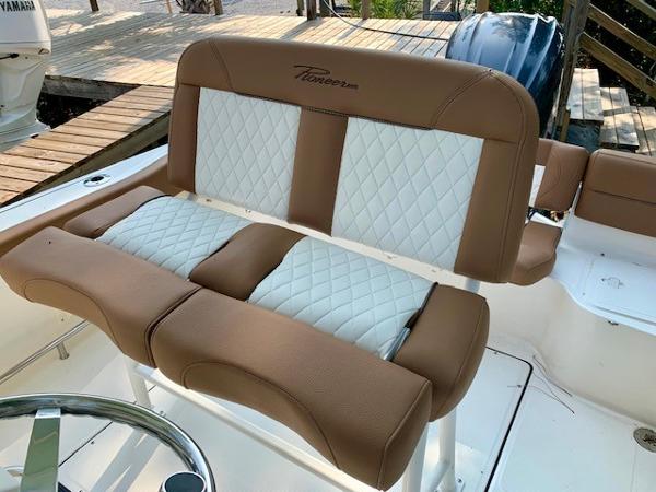 2025 Pioneer 222 Islander boat seat with brown and white quilted upholstery.
