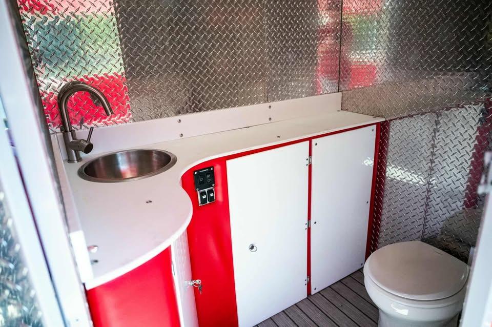 Interior of 2024 Aloha Pontoon 50' Water Taxi with sink and toilet.