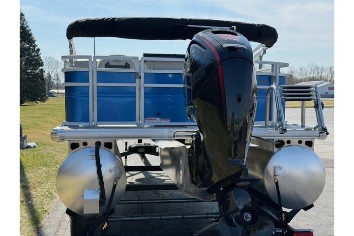 2026 Sun Tracker Fishin' Barge 20 DLX pontoon boat with outboard motor, rear view.