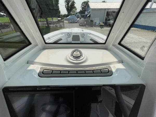 2025 Tidewater 232 CC Adventure boat dashboard with compass and windshield view.