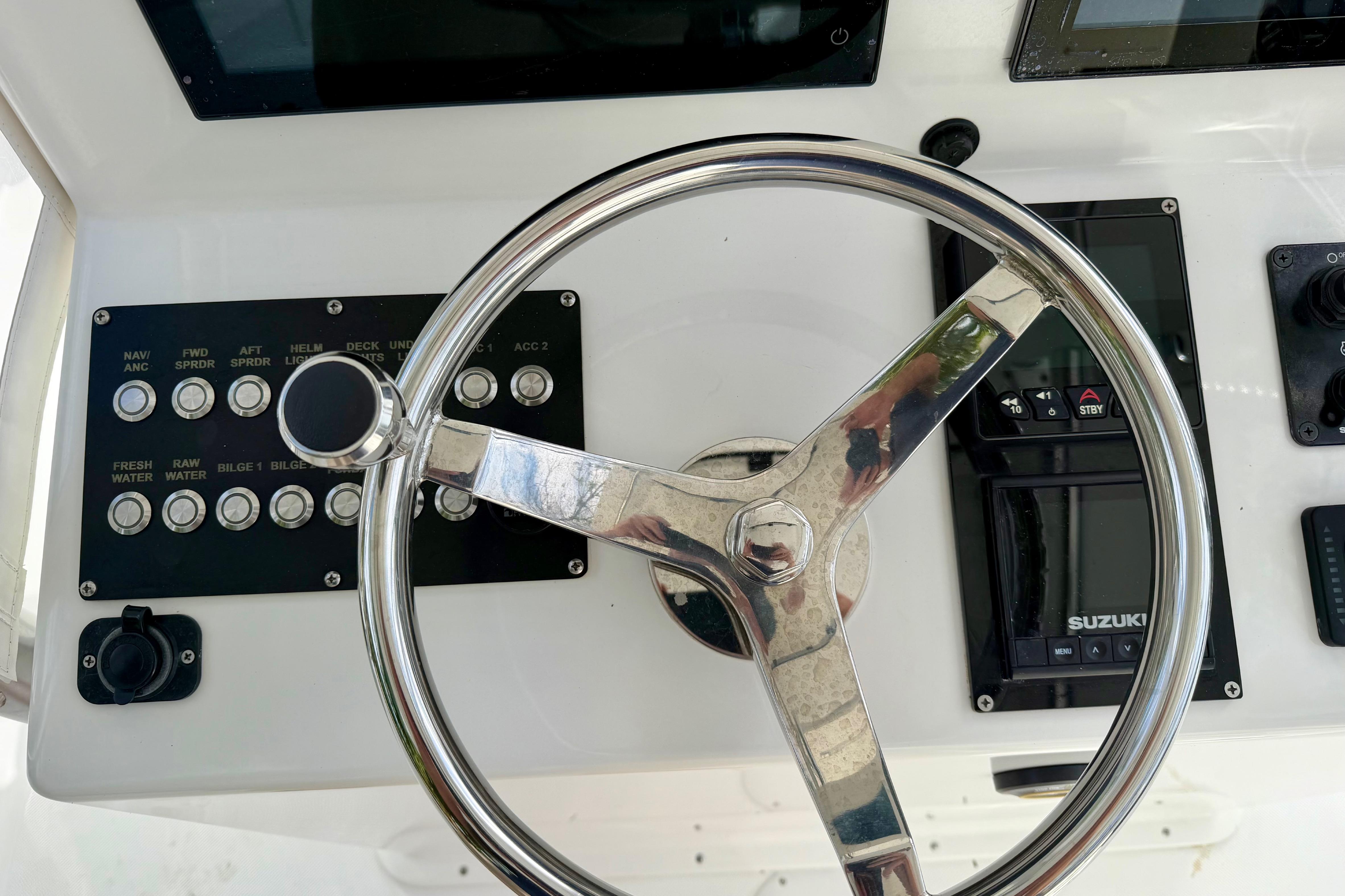 Steering wheel and controls of 2025 Ocean Master 296 Center Console boat.
