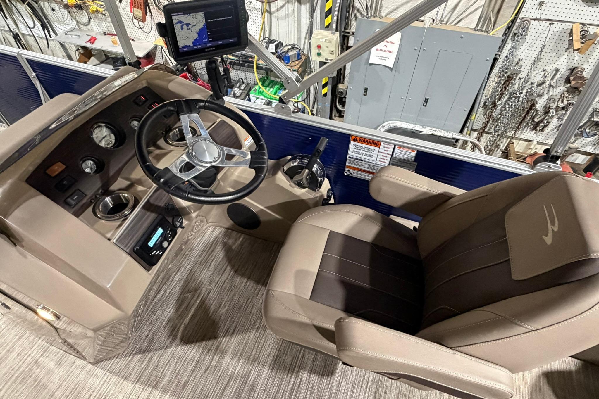 2020 Bennington SX 22 SFX boat cockpit with steering wheel and navigation system.