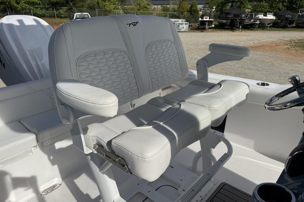 2026 Tidewater 232 LXF boat interior with dual captain's seats and steering wheel.