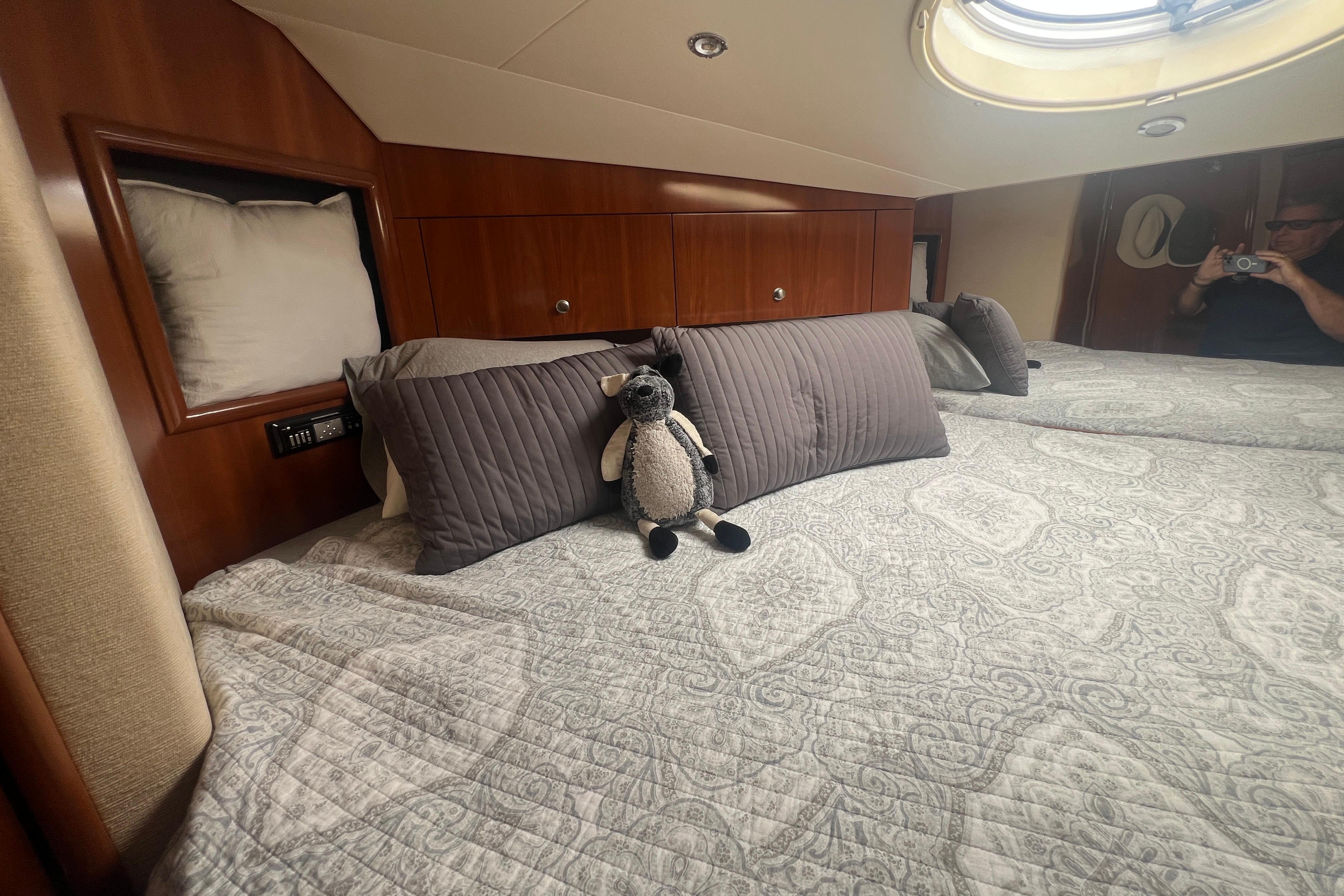 Luxurious 2006 Carver 43 Motor Yacht bedroom with plush bedding and elegant wood paneling.