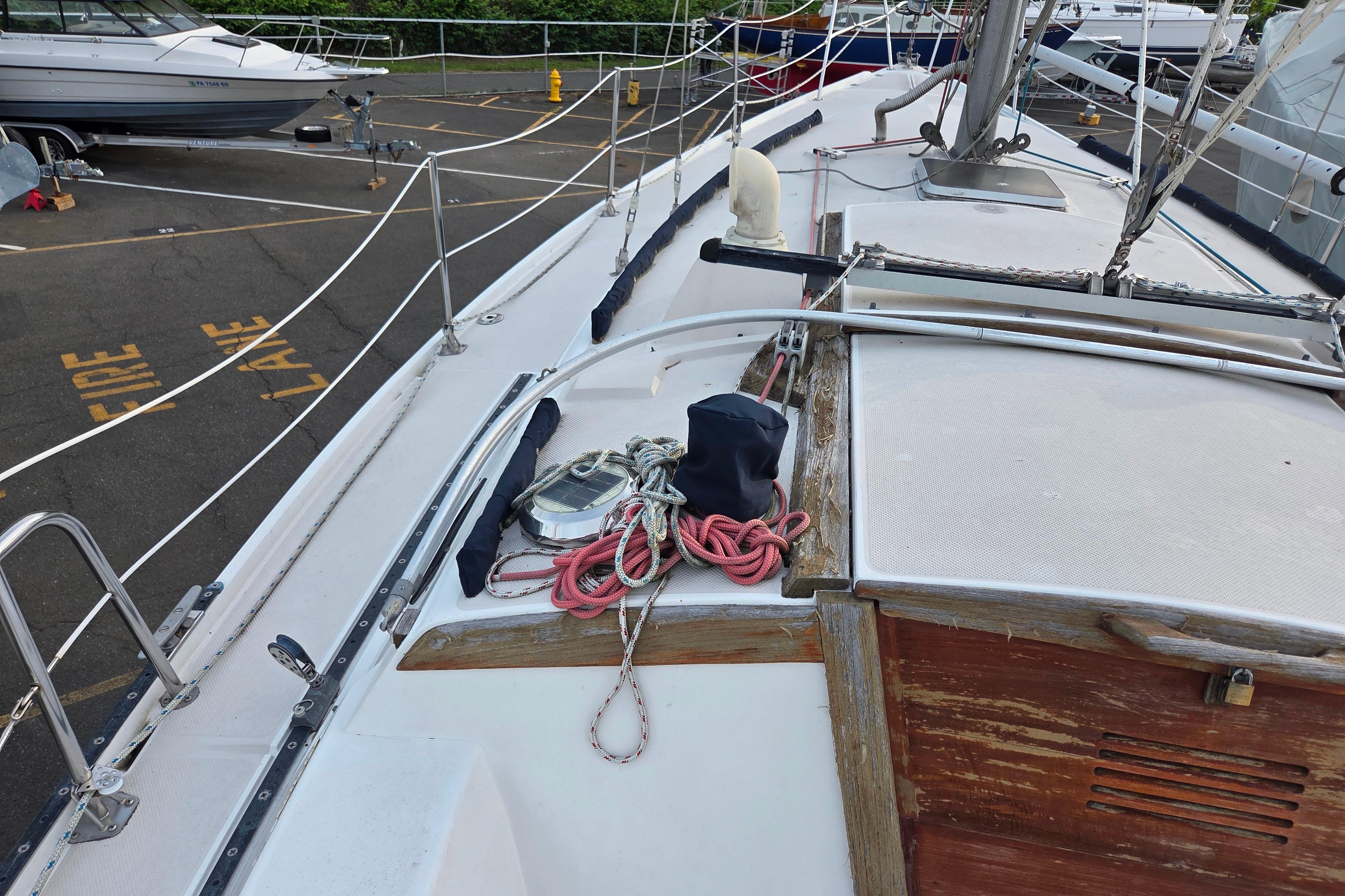 1986 Catalina 355 sailboat deck with ropes and fittings in a marina.