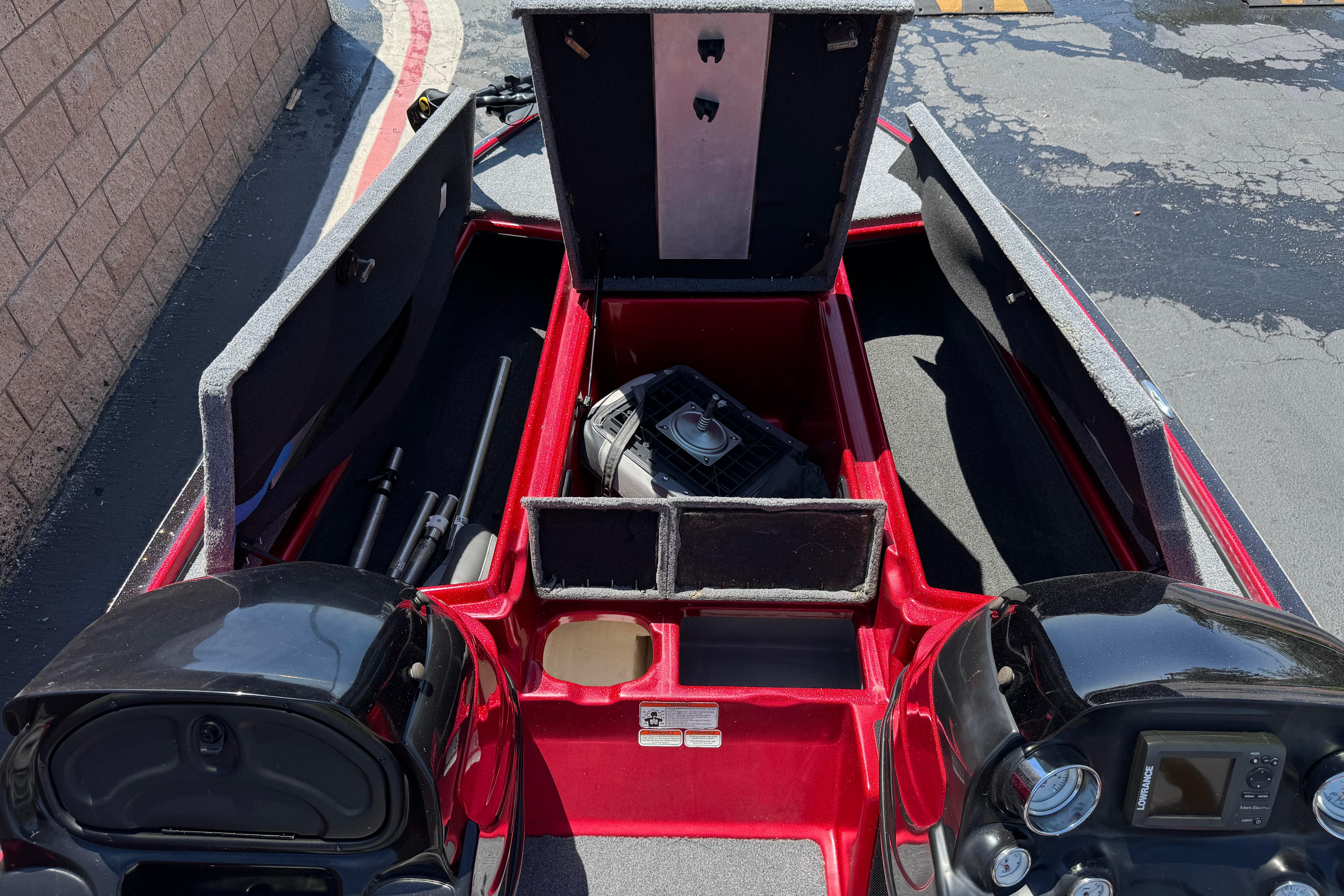 Open storage compartments on a 2012 Nitro Z-7 boat, showcasing interior equipment and layout.