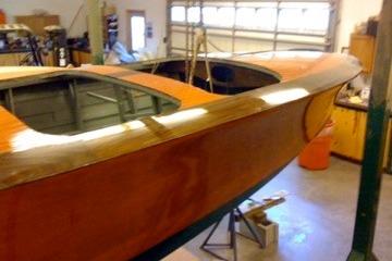1931 Hacker-Craft 26 Dolphin wooden boat in a garage setting.