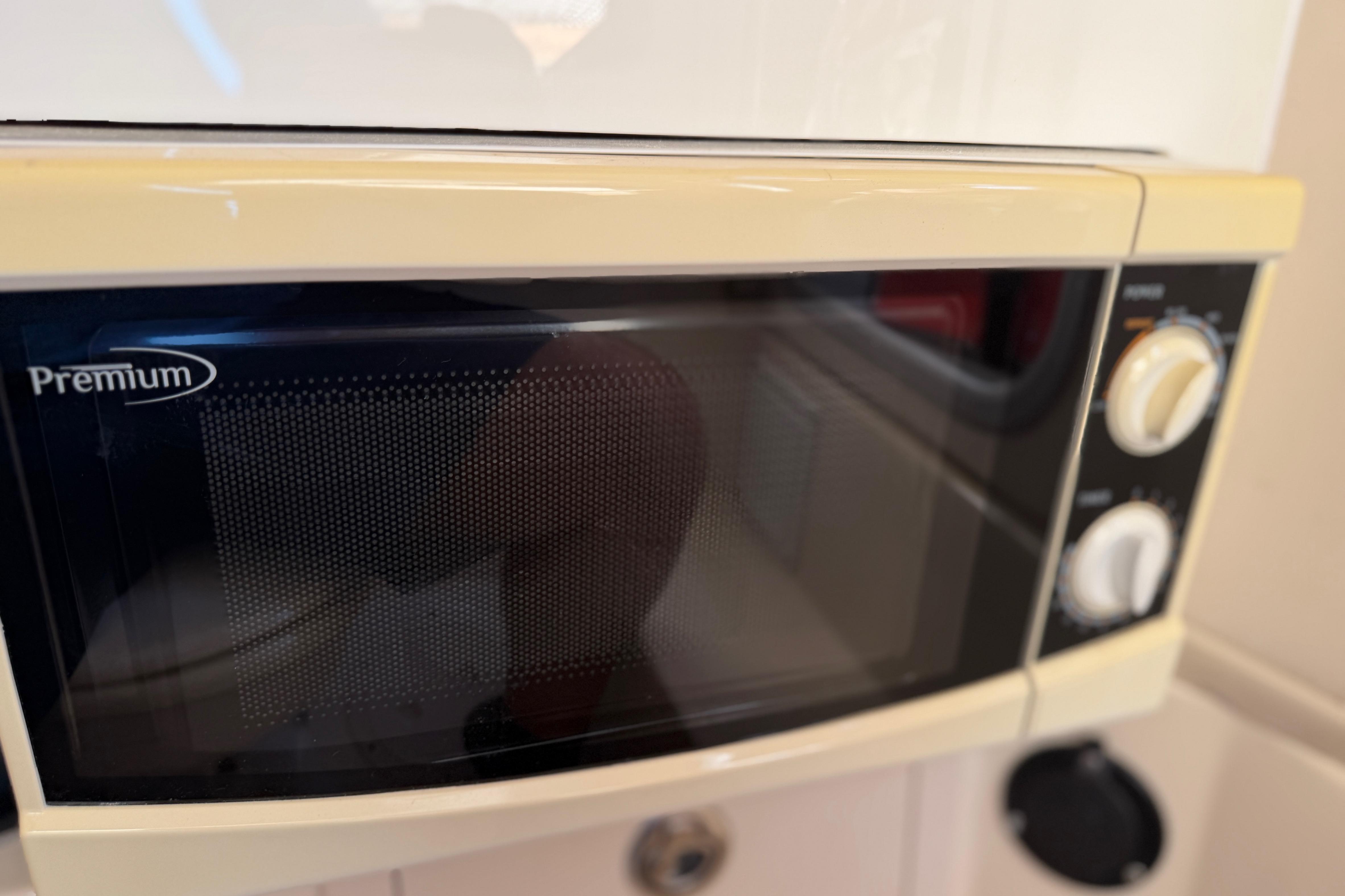 Microwave oven inside 2004 Grady White 273 boat kitchen area.