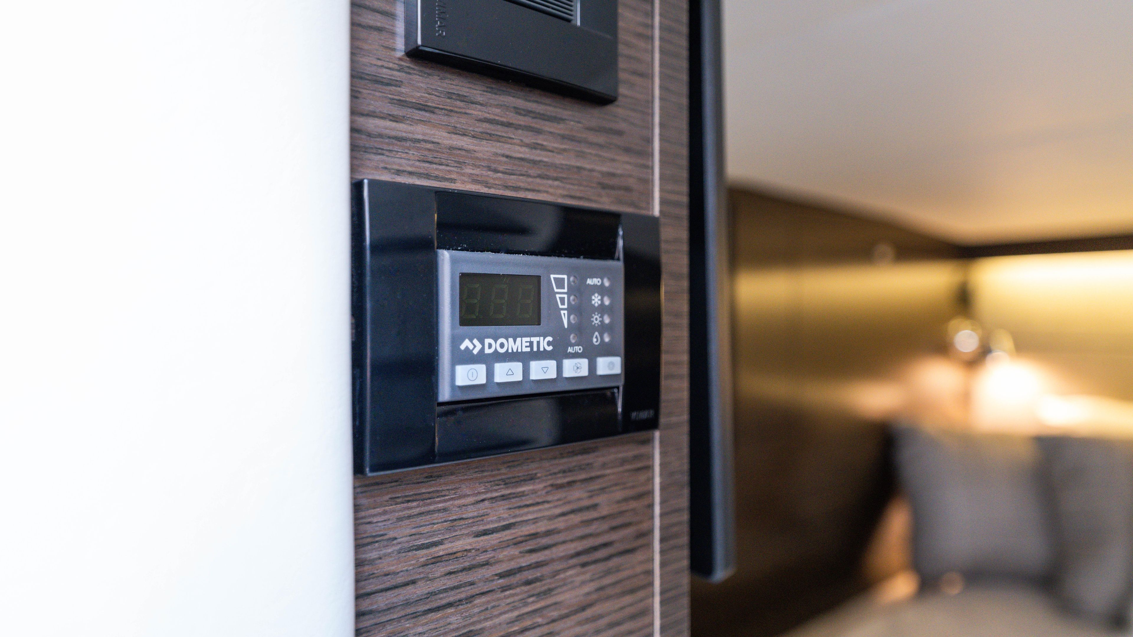 Dometic control panel on 2020 Cruisers Yachts 38 GLS OB interior wall.