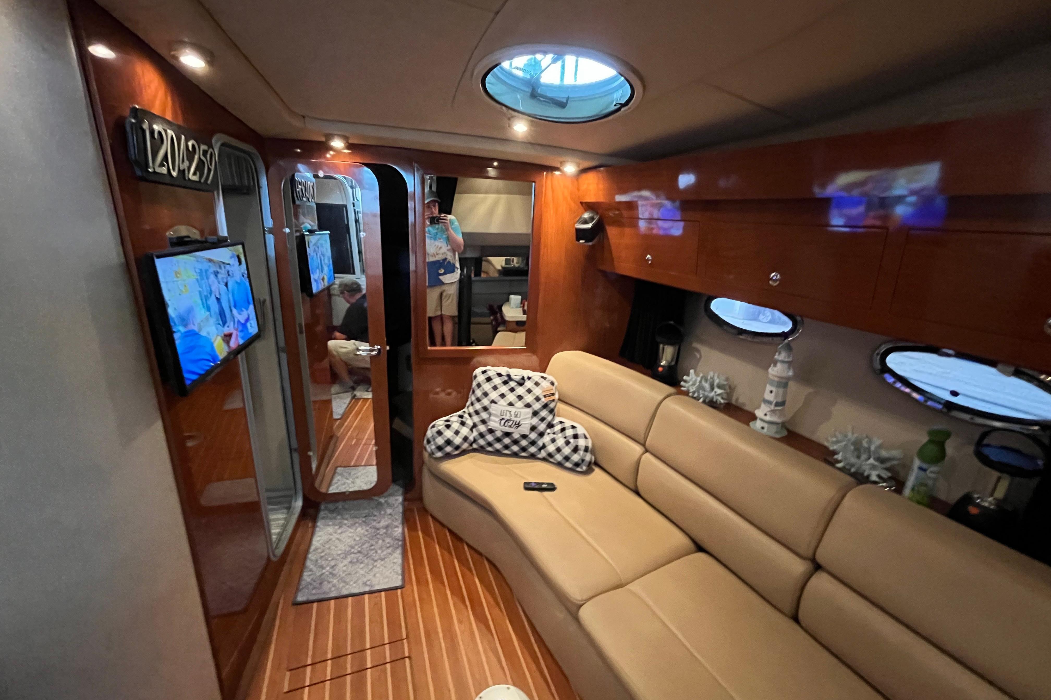 Luxurious interior of 2007 Regal 3760 IB Commodore yacht with cozy seating and decor.
