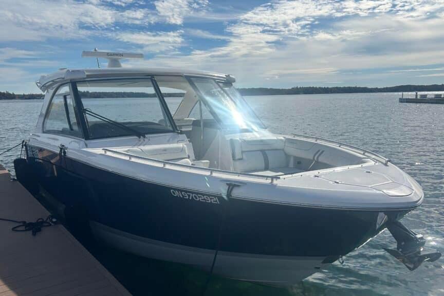 2025 Regal LS36 boat docked on a sunny day with calm waters.
