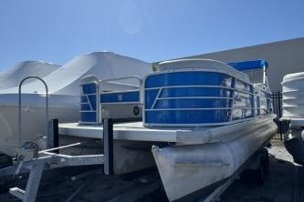 2021 Godfrey Sweetwater 2286 C pontoon boat with blue accents, parked outdoors.