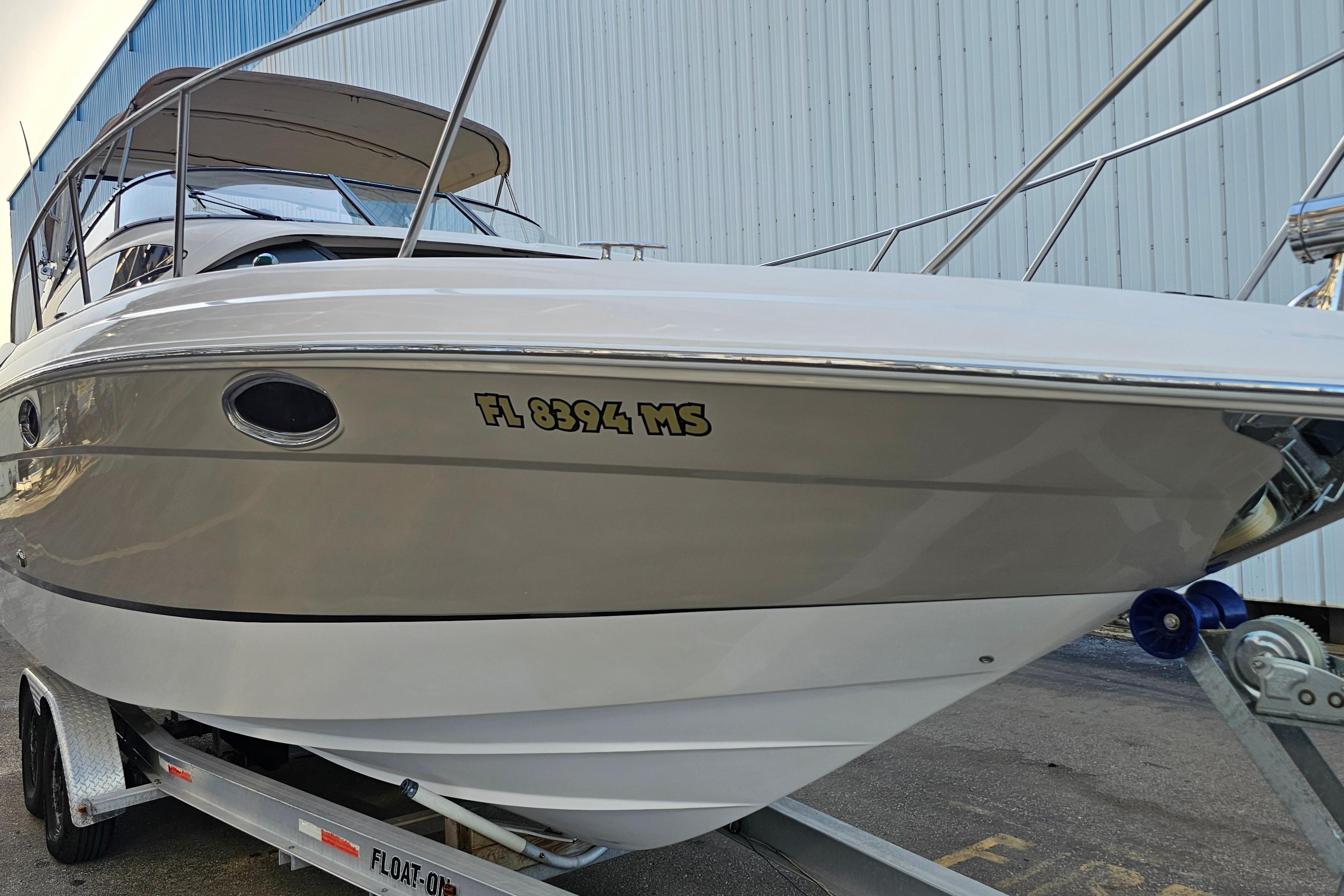 2005 Regal 3060 Window Express boat on trailer, side view.