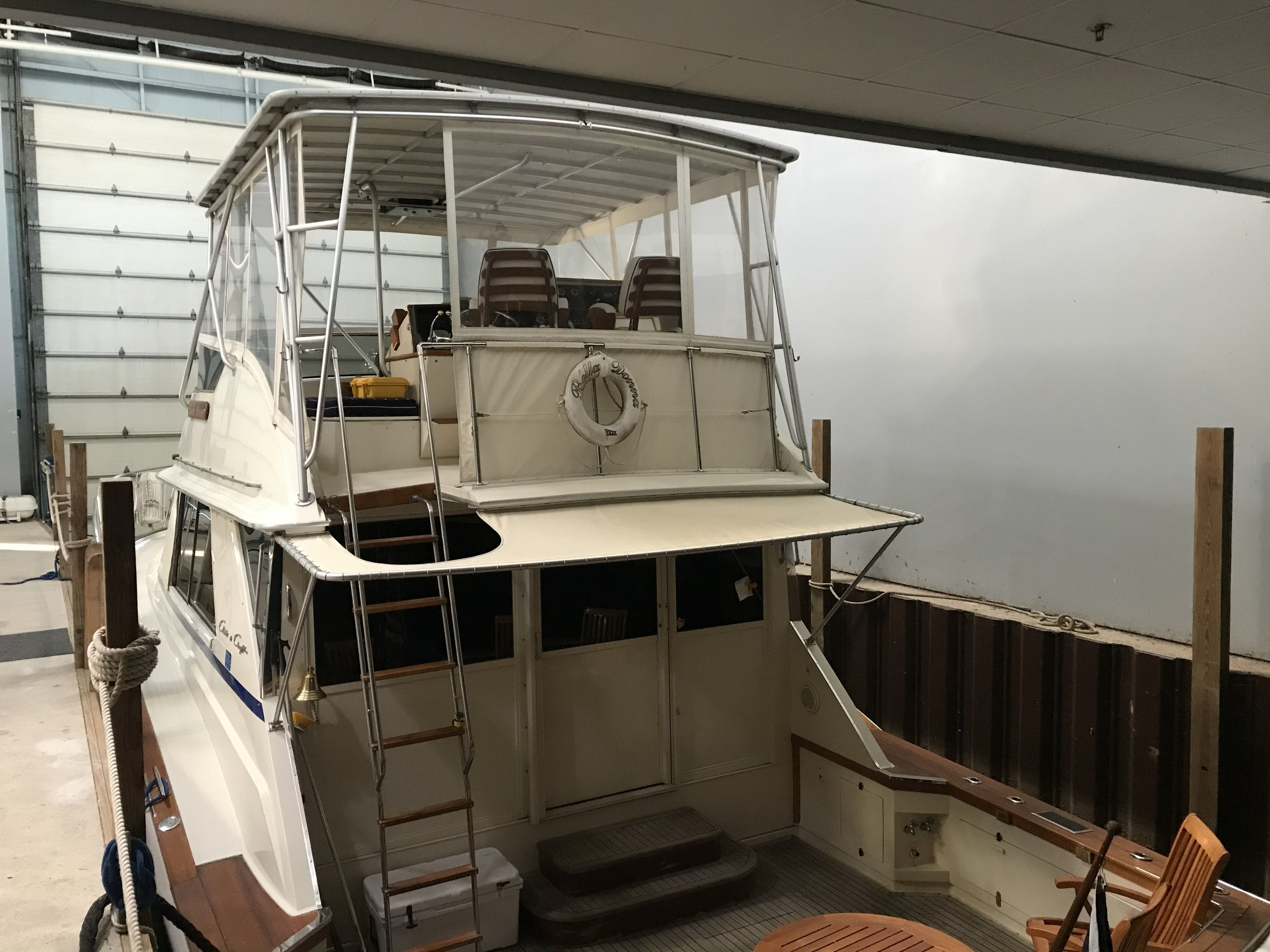 A 1979 Chris-Craft 45 TF in a storage facility with wooden furniture on the deck.