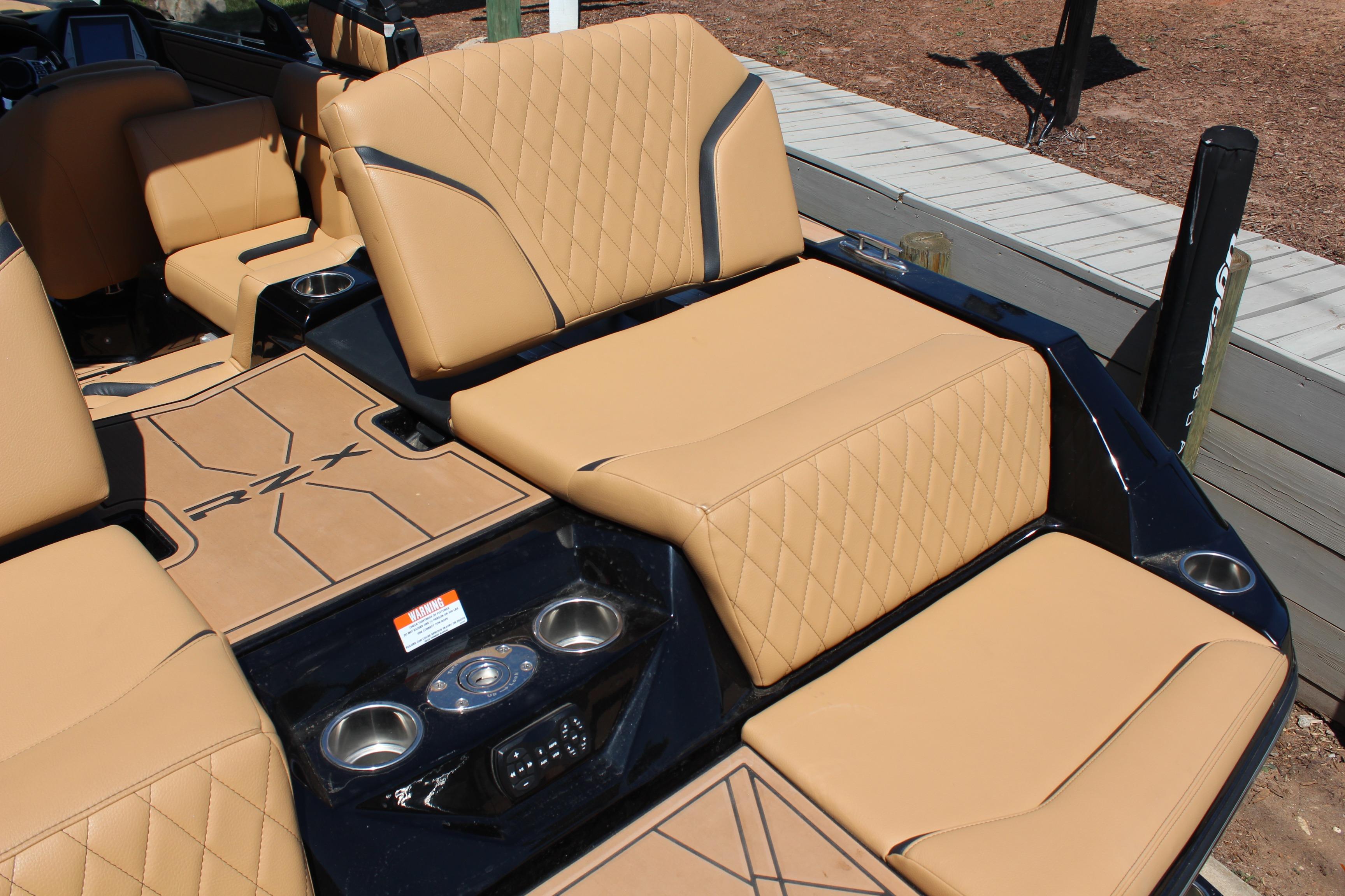 2022 Tigé 22RZX boat interior with tan diamond-stitched seats and cup holders.