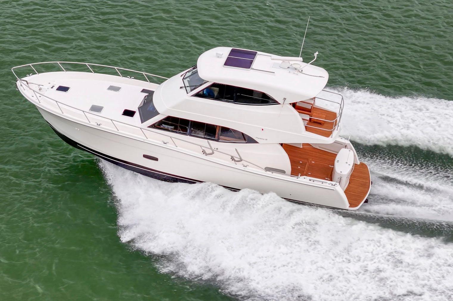 2014 Maritimo M50 yacht cruising on open water, aerial view.