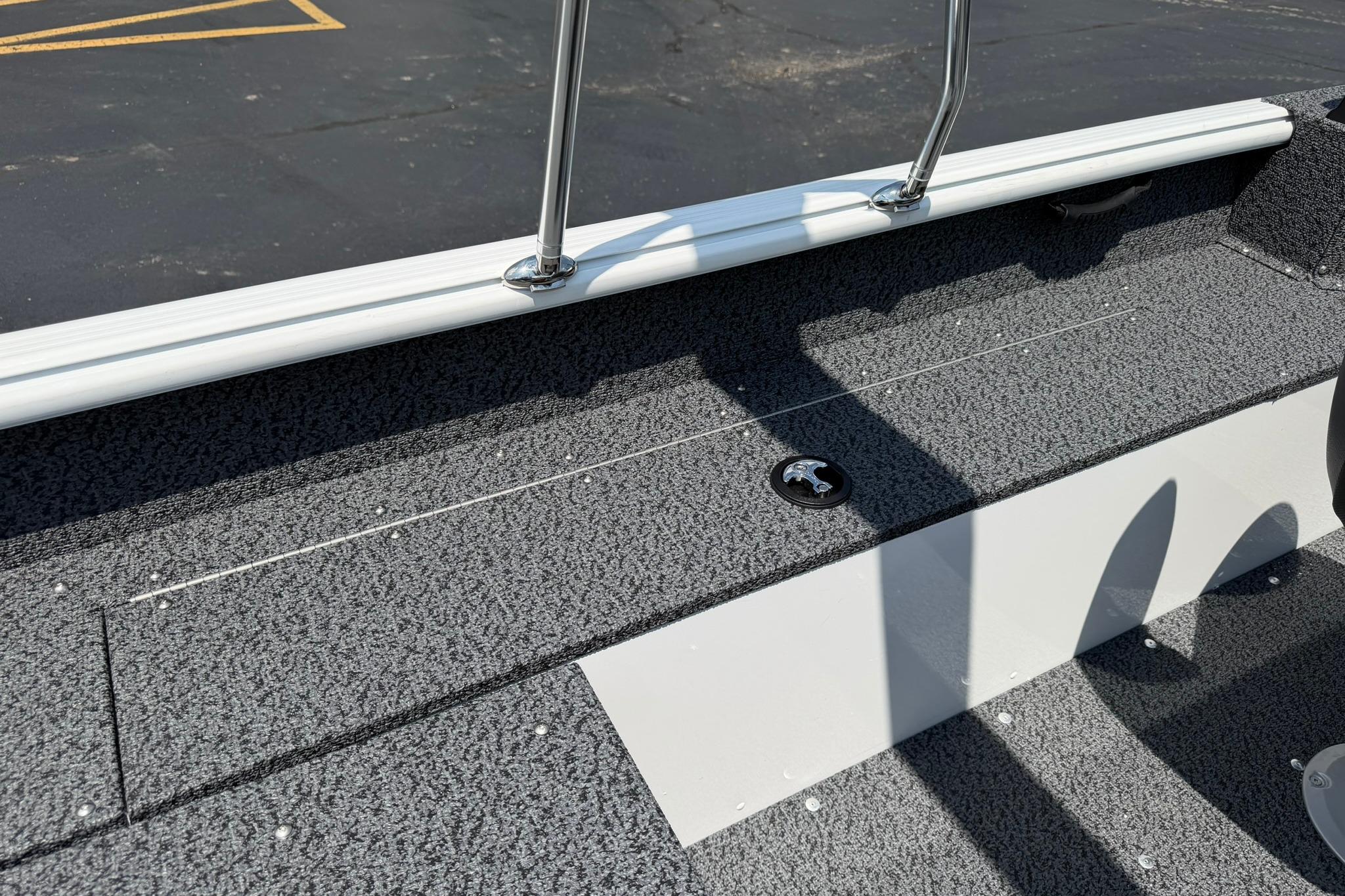 2027 Lund 1675 Adventure Sport boat deck with textured flooring and railing.