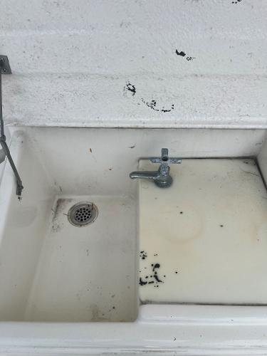 Old sink with faucet, stained surface, aboard 1985 Hatteras 45 Convertible boat.