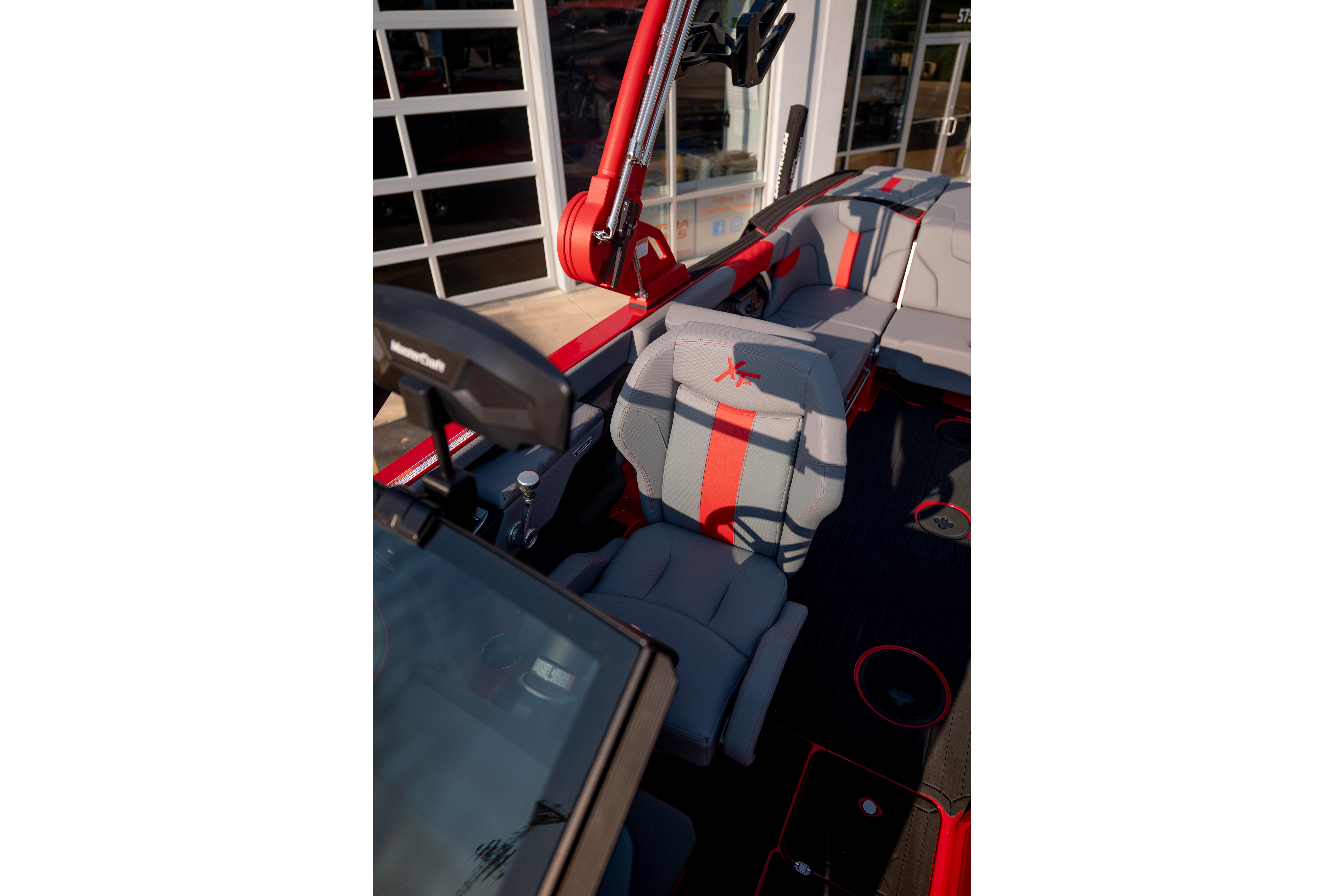 Interior of 2027 MasterCraft XT24 boat with modern seating and red accents.