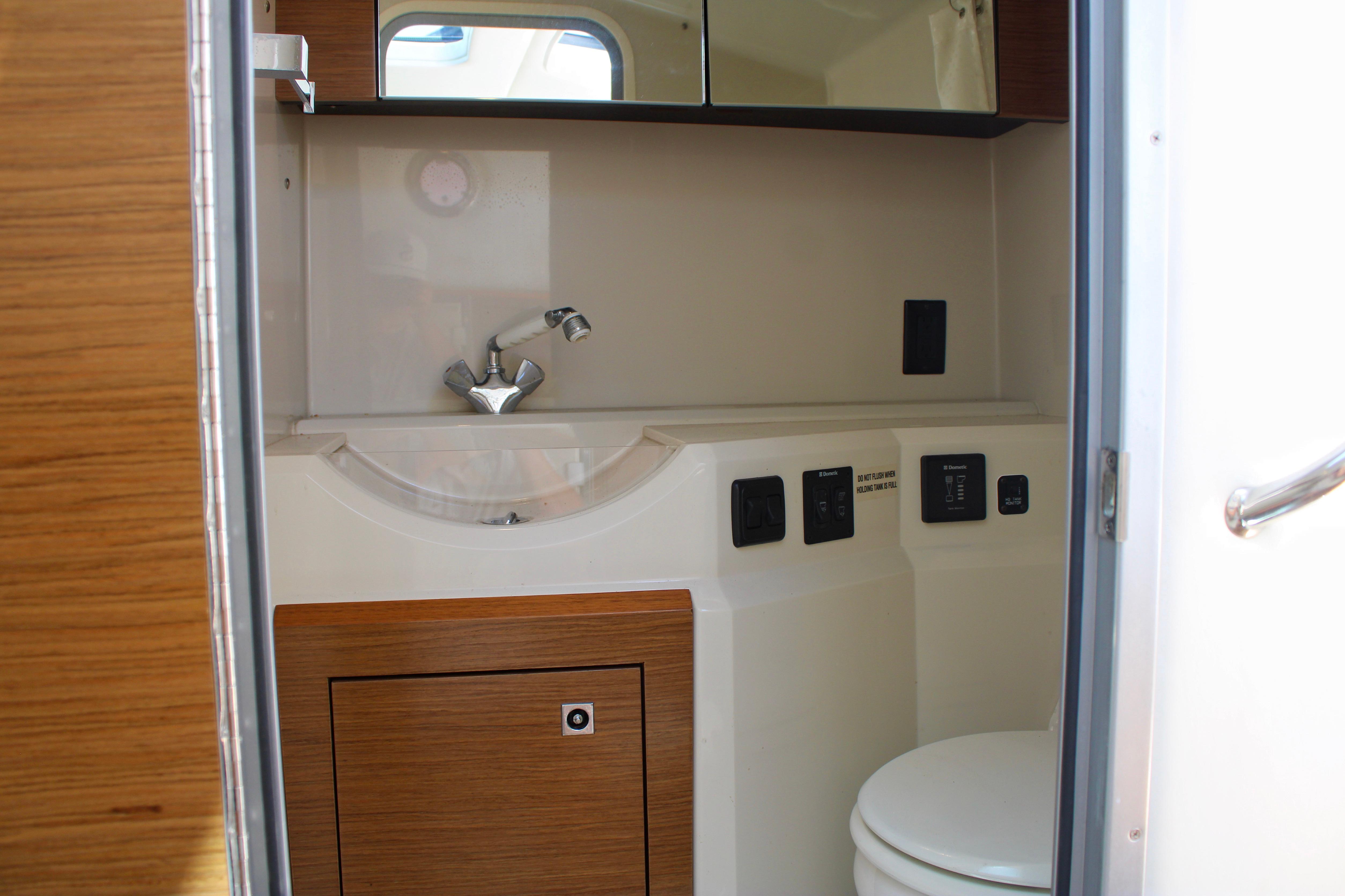 2017 Cruisers Yachts 338 Bow Rider bathroom interior with sink and toilet.