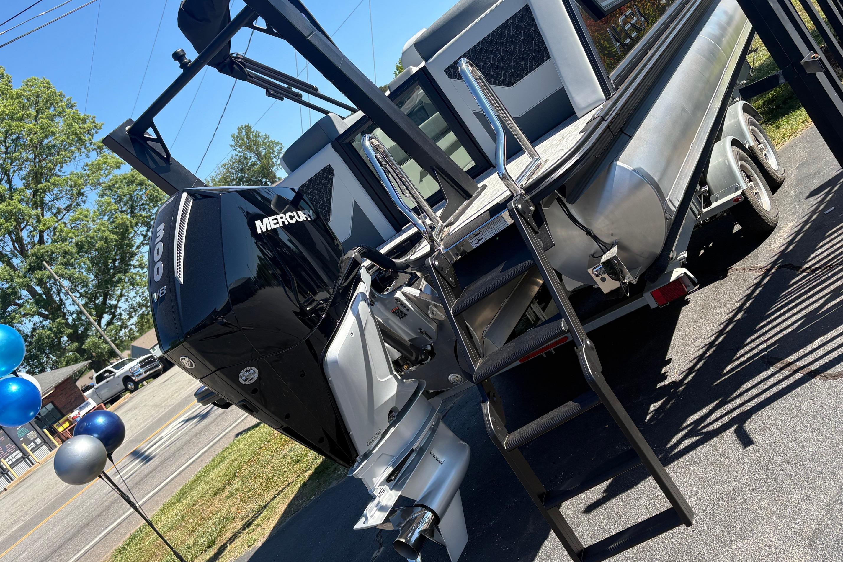 2026 Alera 23Q boat with Mercury 300 V8 engine on trailer, parked outdoors.