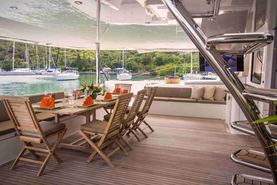 Luxurious 2007 Matrix Yachts Silhouette 760 with elegant outdoor dining area and scenic marina view.