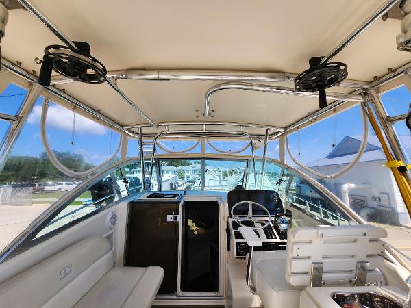 2005 Pursuit 3070 Offshore Center Console interior with helm, seating, and storage compartments.