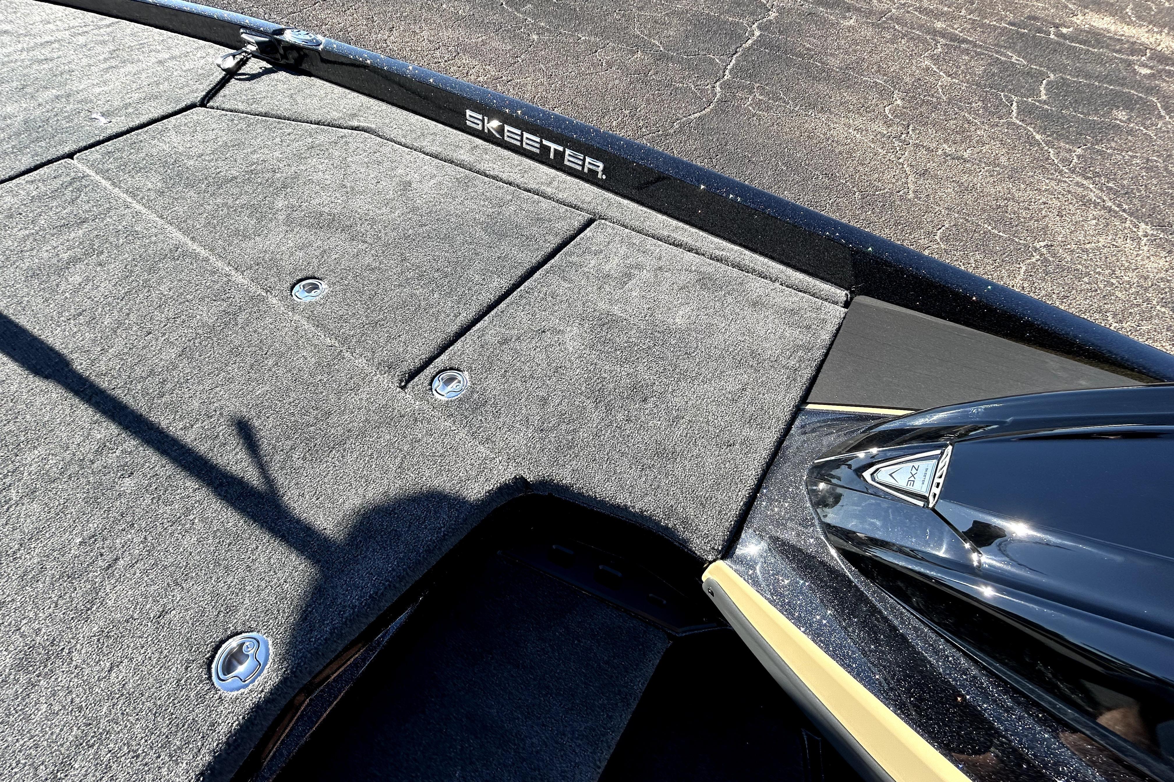 2026 Skeeter ZXE21 boat deck with carpeted surface and storage compartments.