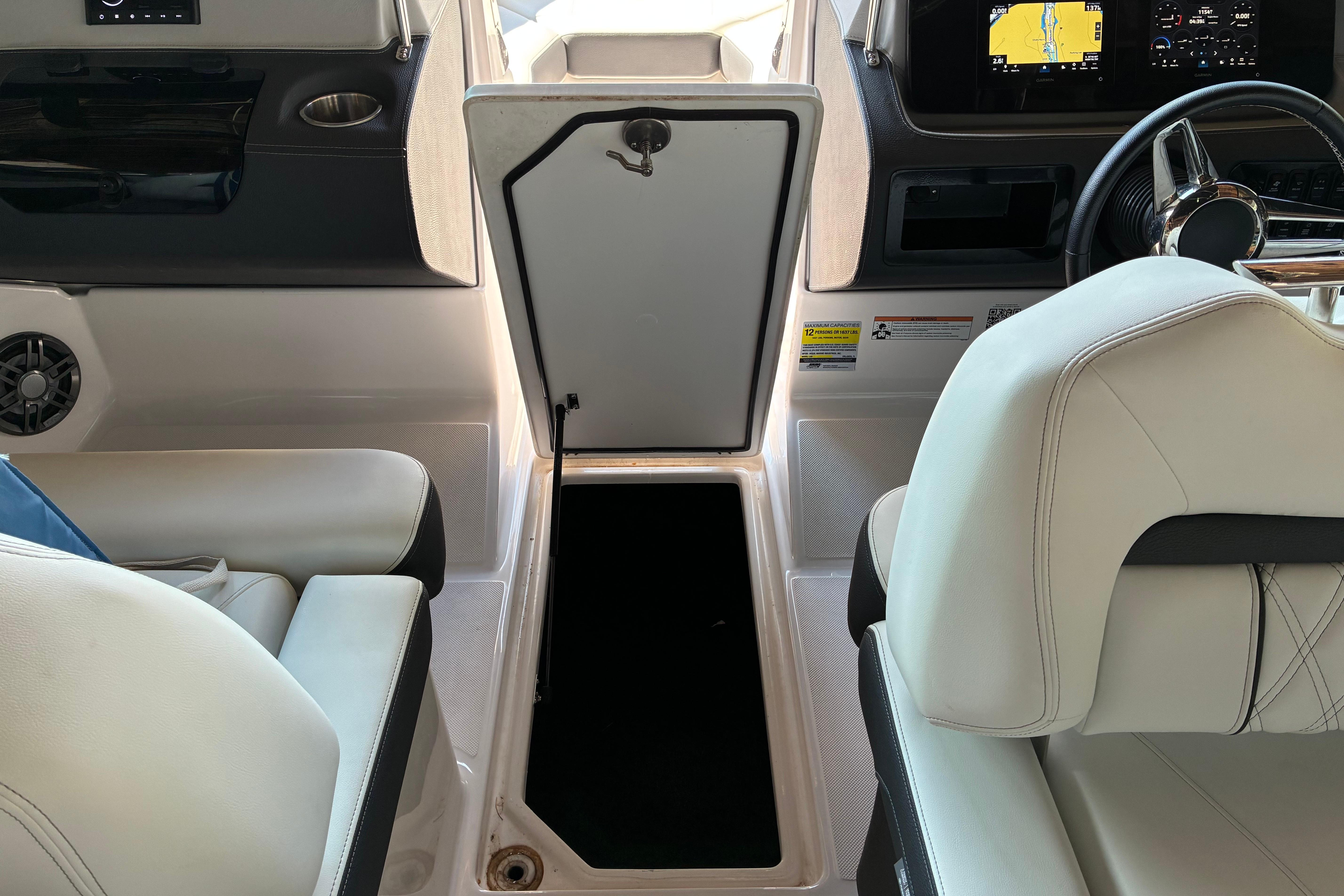 Interior of 2025 Regal LS2 boat with open storage compartment and modern dashboard.