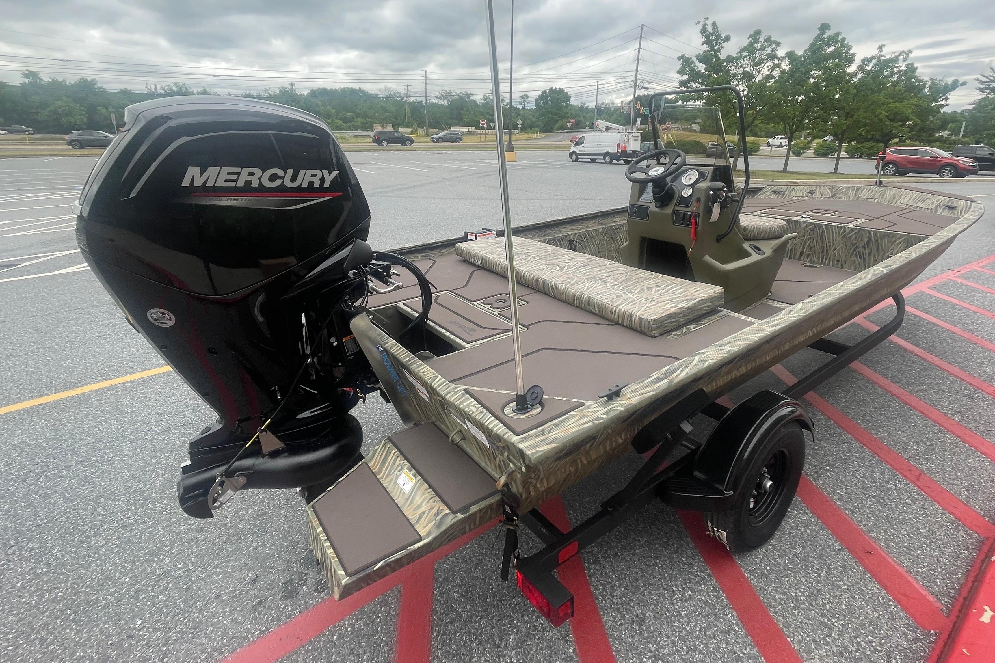 2026 Tracker Grizzly 1860 CC boat with Mercury engine, parked on a trailer.