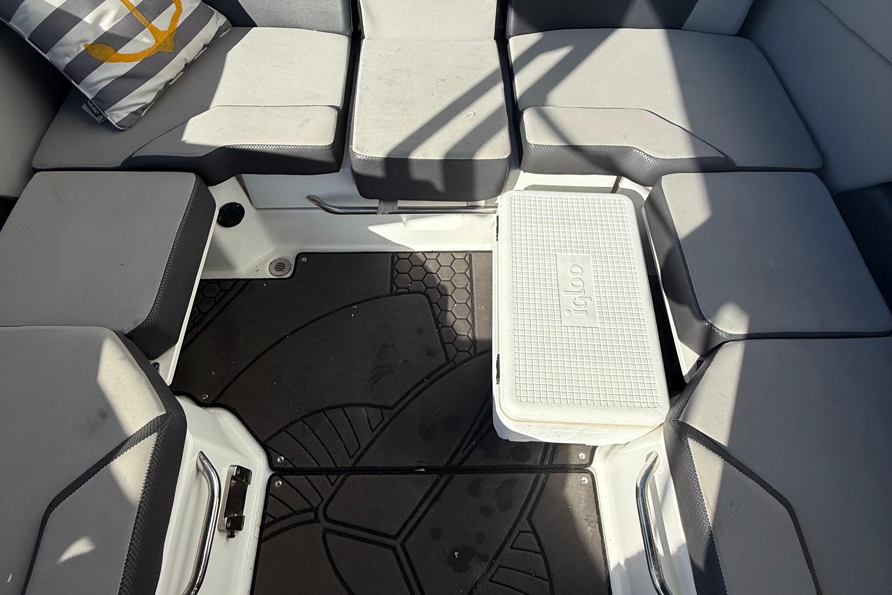 2021 Scarab 255 ID boat interior with cushioned seating and Igloo cooler.