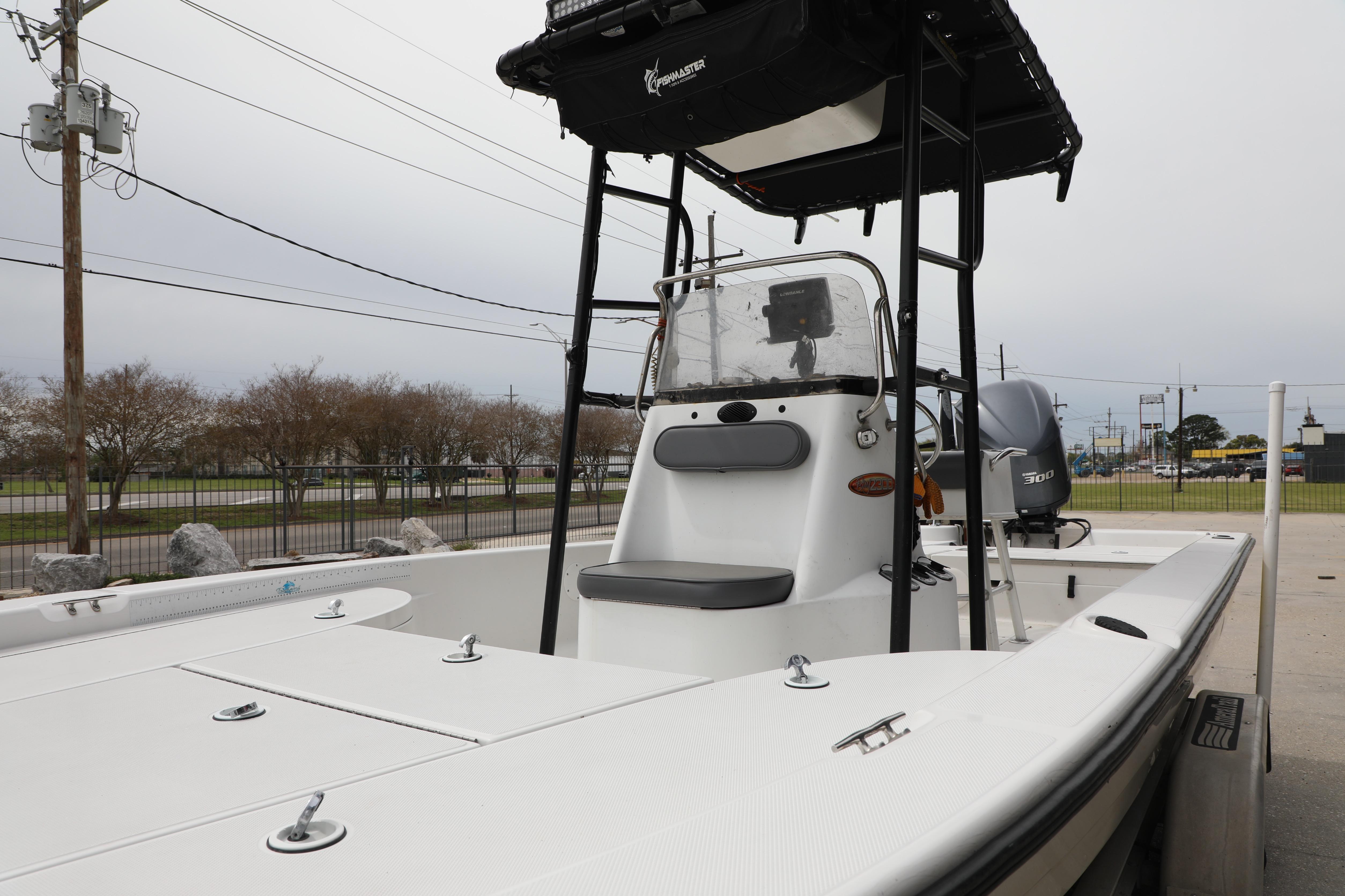 2002 Ranger 2300 Bay Ranger boat with center console and T-top, parked outdoors.